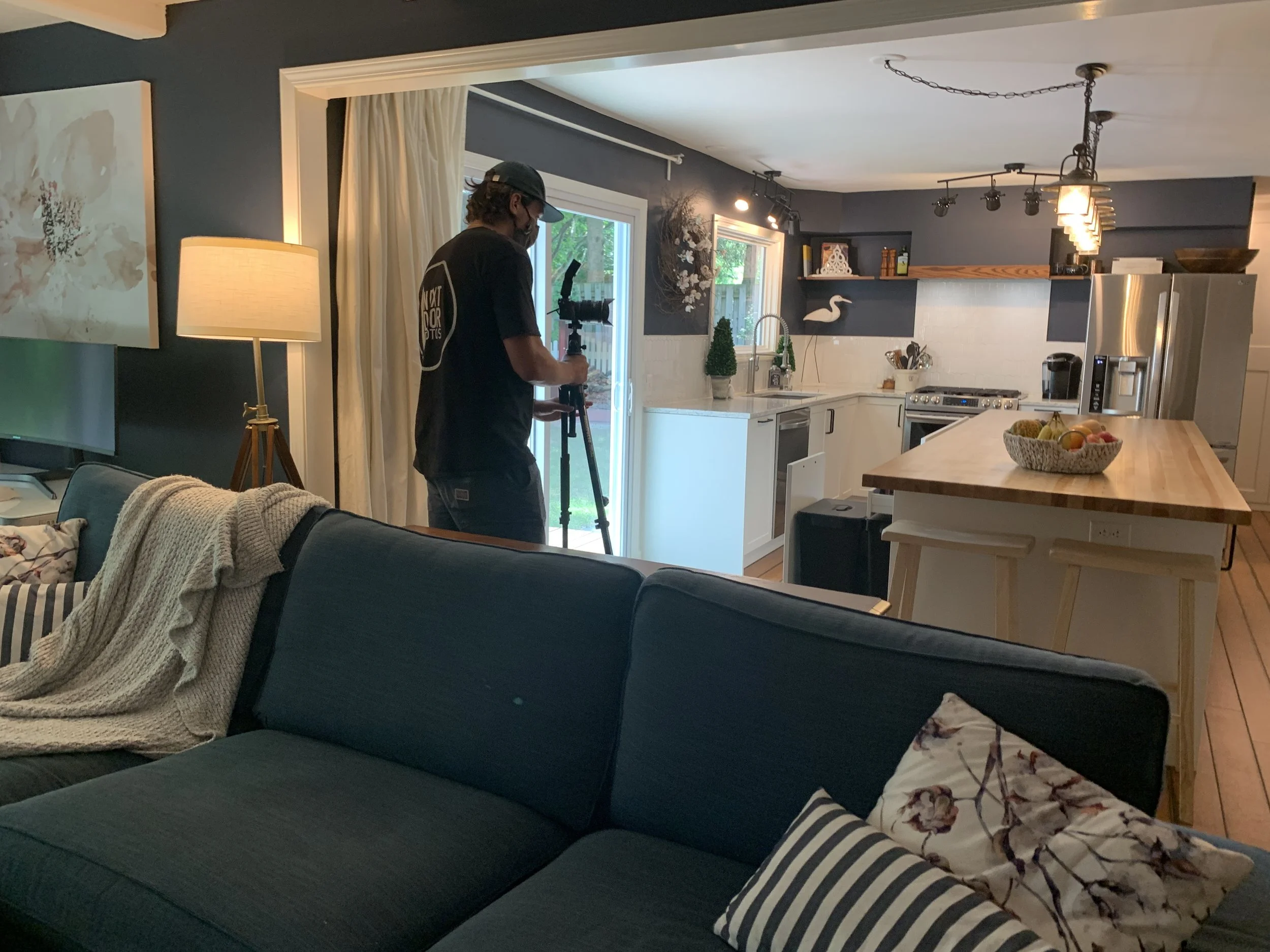 Photographer setting up camera to photograph kitchen.