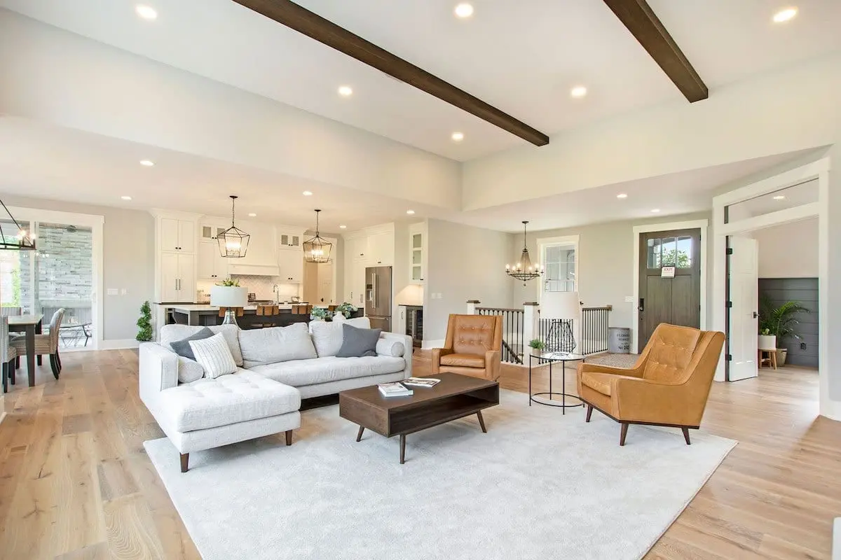 Staged shot of an upscale living room looking into the kitchen.