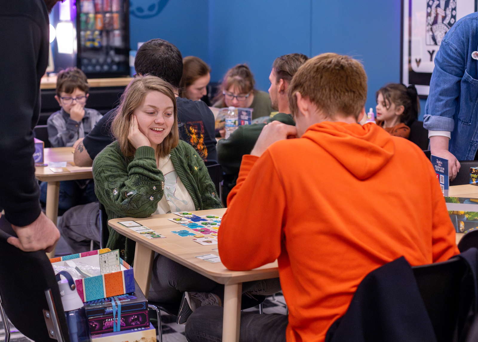 People playing a board game at a table in the Crate.