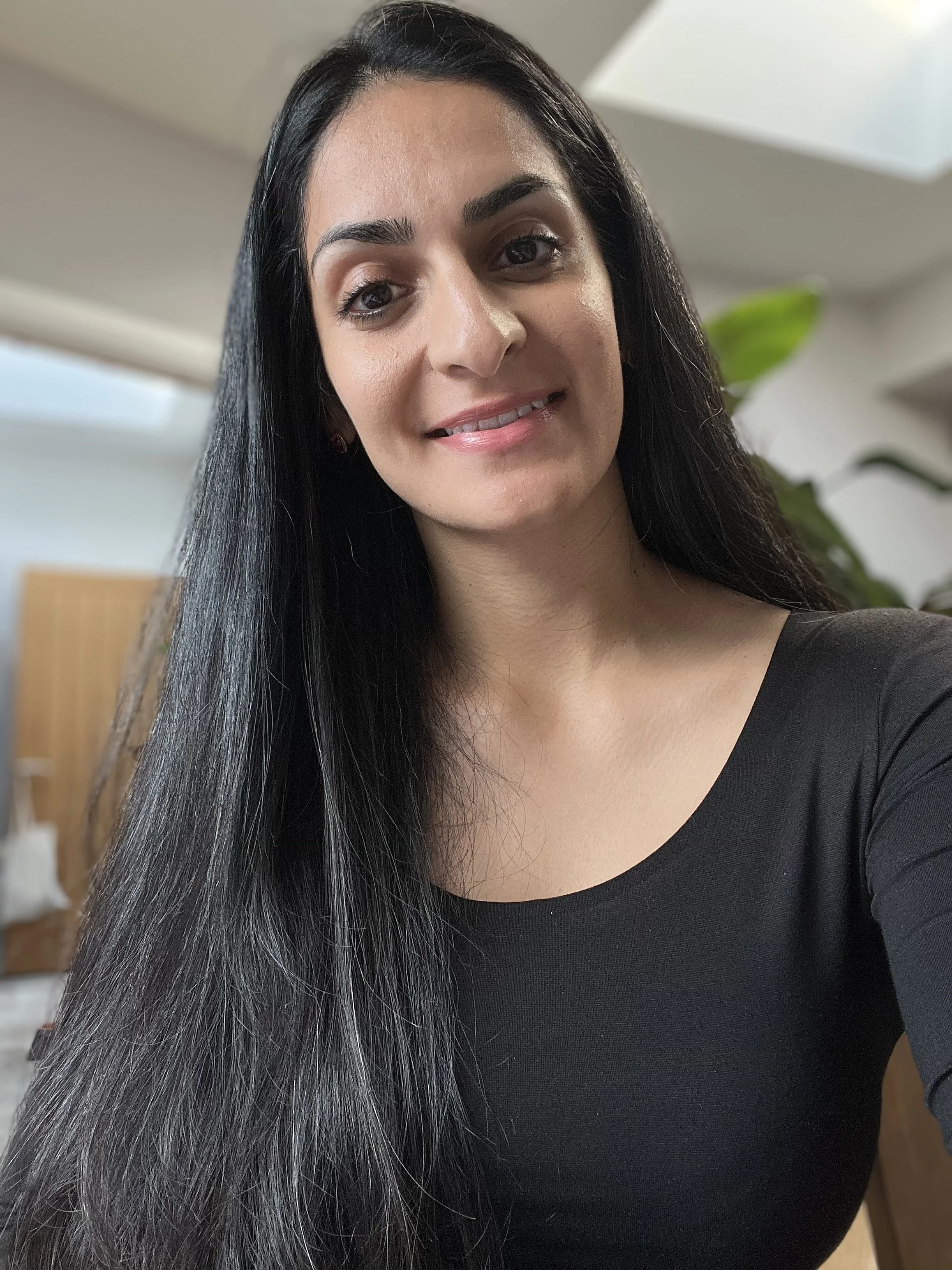 Nyla Khan, women's workshop facilitator, sitting indoors