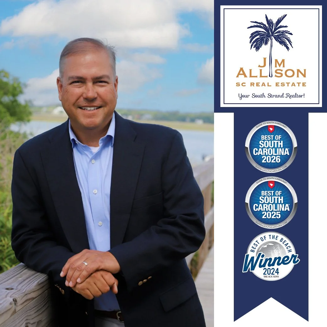 Photo of a smiling man in a suit jacket and blue shirt, outdoors near a water body with green trees in the background, and logos on the right side related to real estate awards and recognitions.