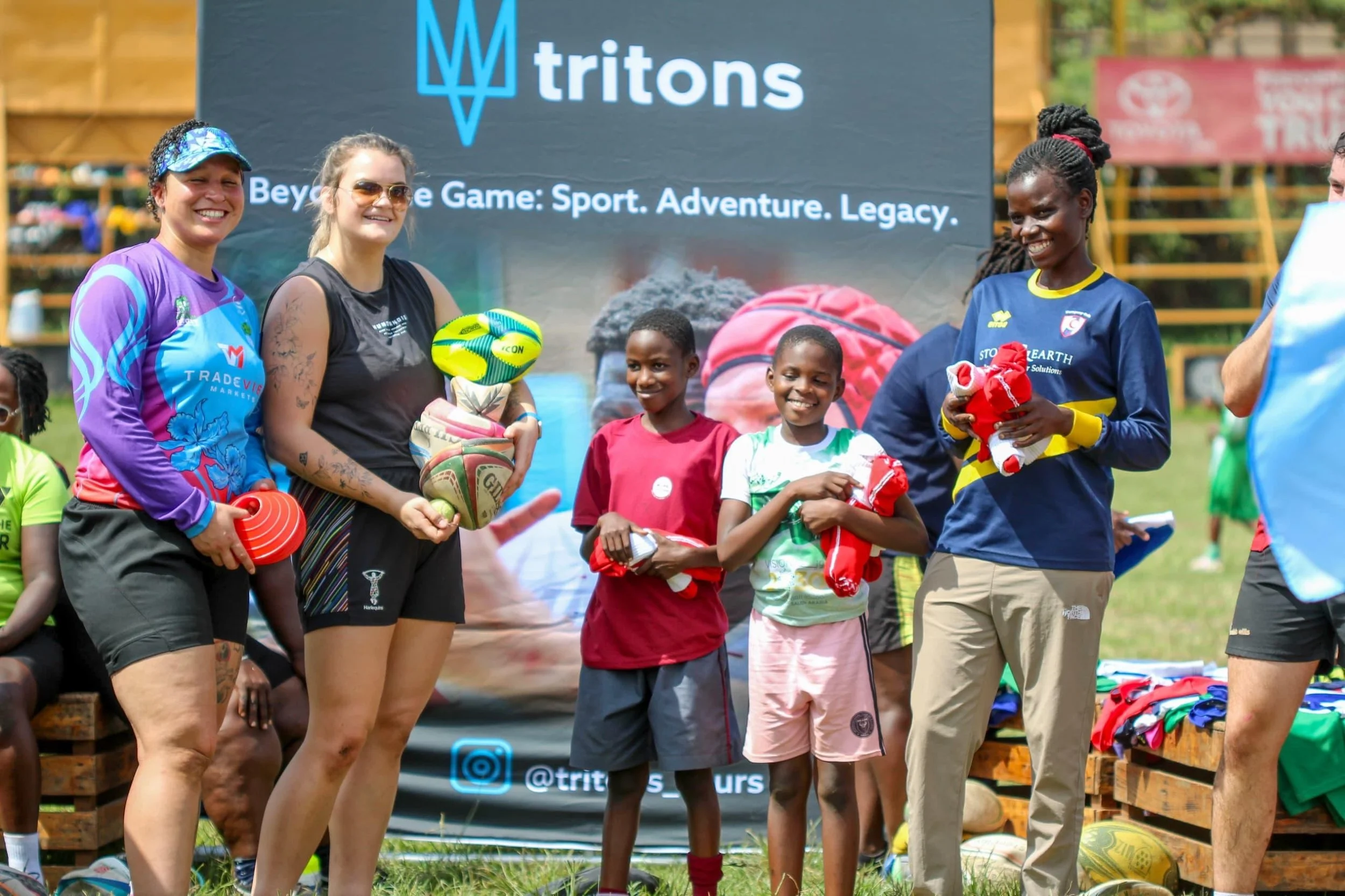 Tritons rugby tour community event in Uganda with players and local children.