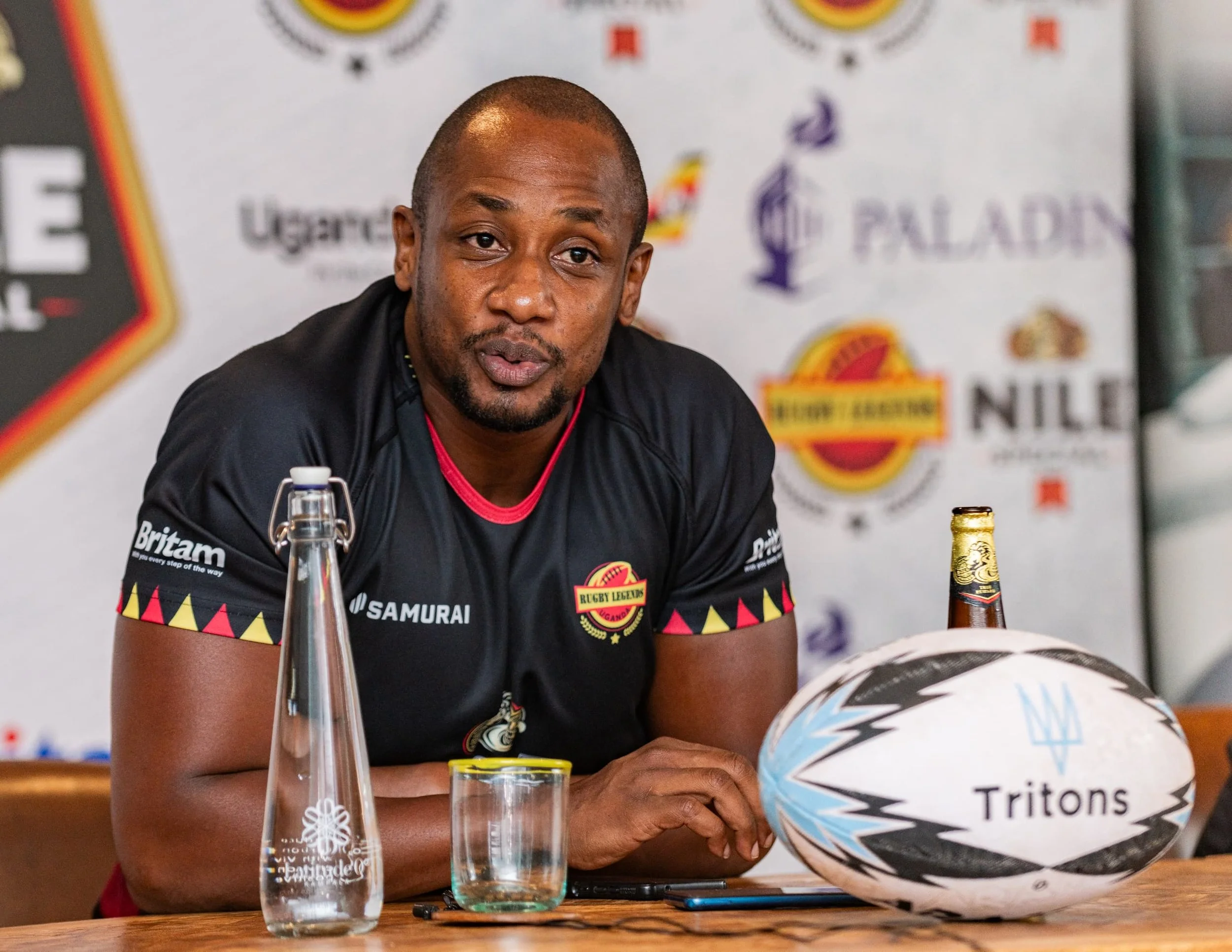 Tritons rugby tour media event in Uganda featuring player interview and sponsorship partners