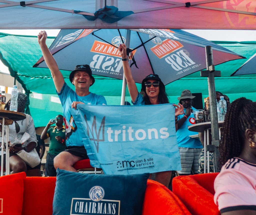 Tritons Tribe supporters at a rugby tour in Uganda celebrating with the team and local community