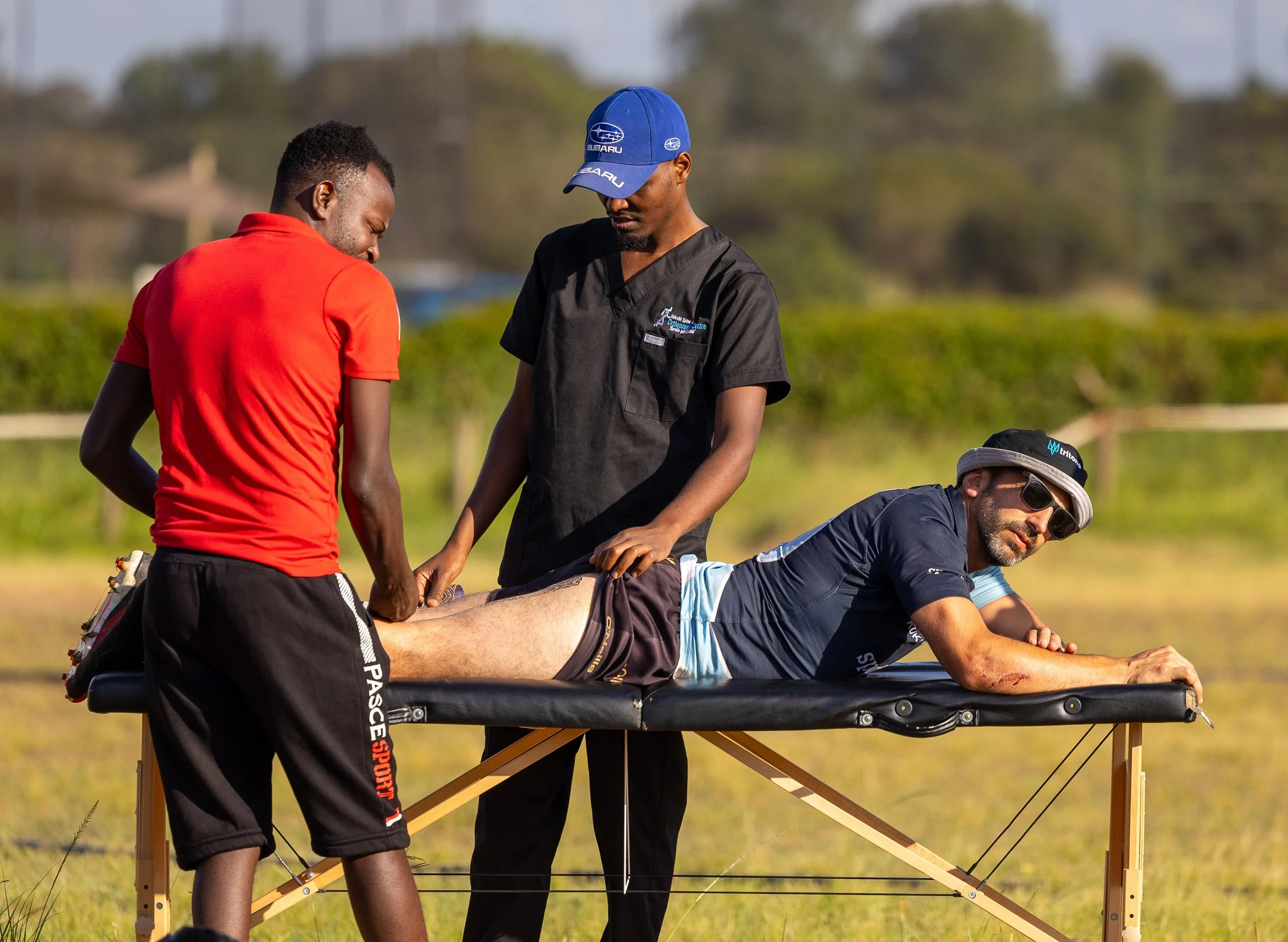 Player recovery session during Tritons rugby tour with team support and treatment.