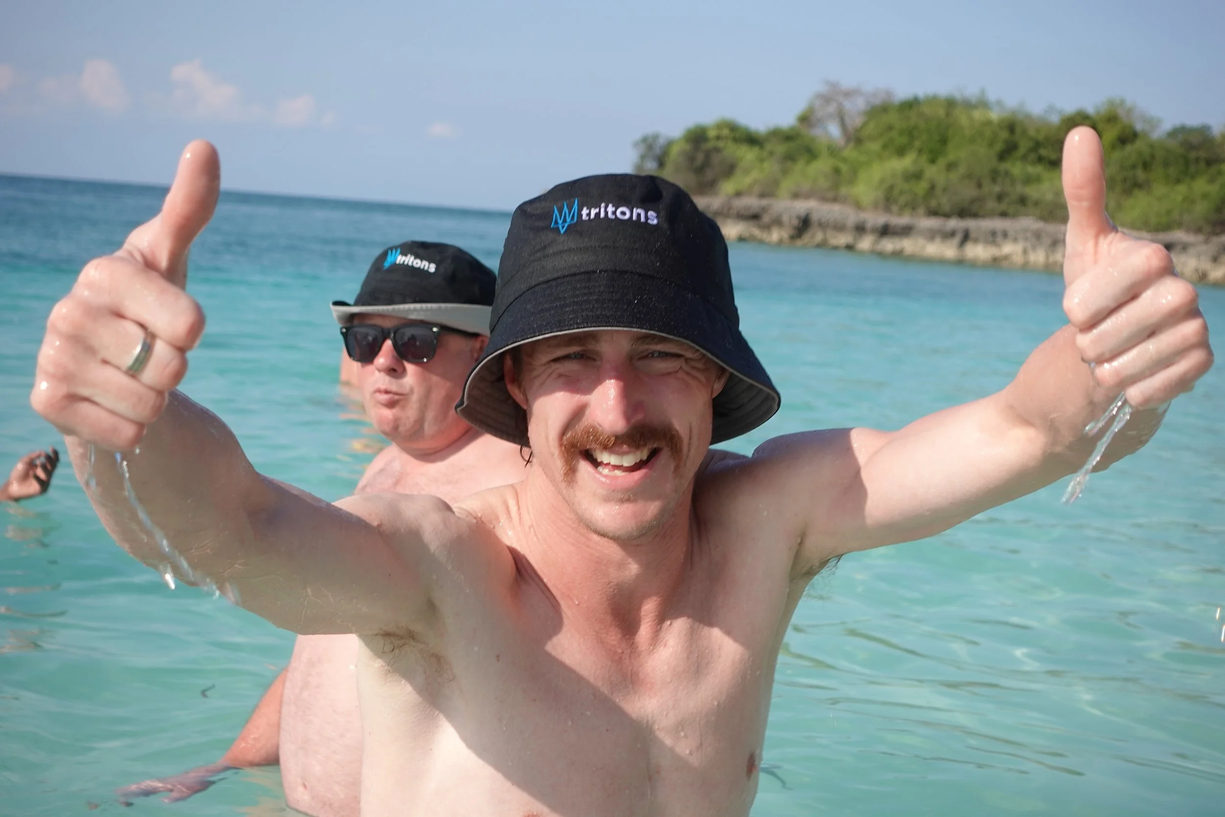 Tritons rugby tour participants enjoying beach experience during international sports tour