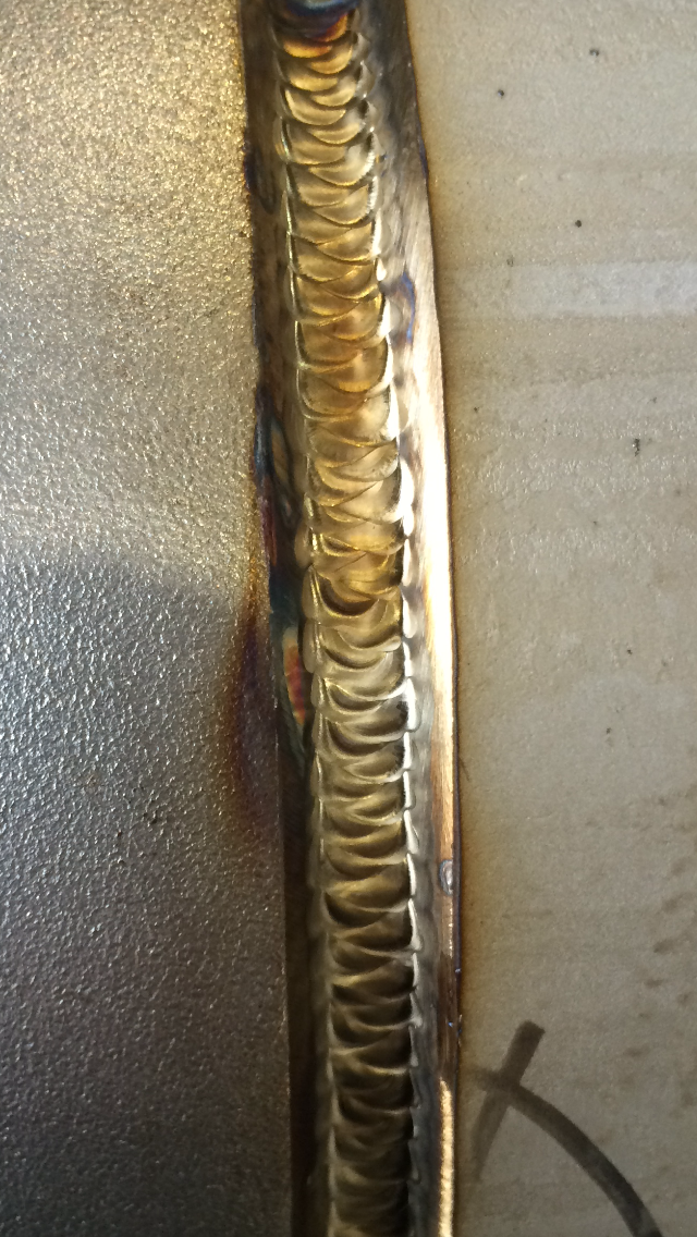 Close-up of a metal TIG weld with distinct rainbow coloring