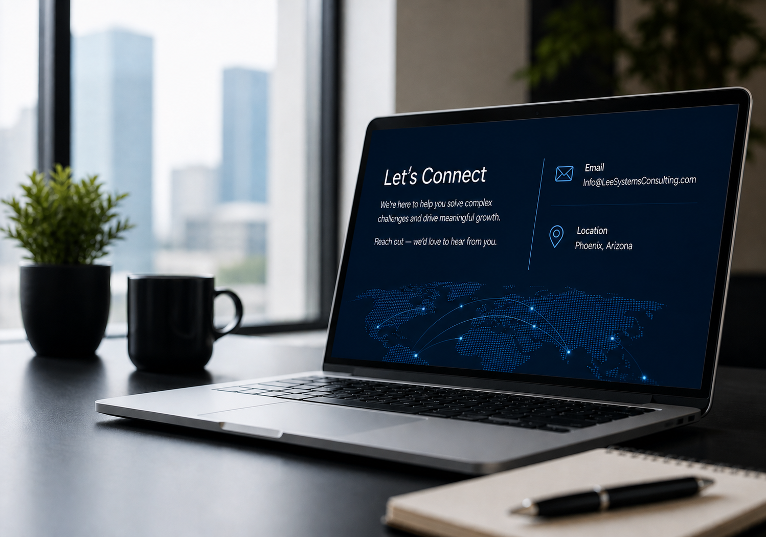 A laptop on a desk displays a contact information page with the header "Let's Connect," showing an email and location in Phoenix, Arizona. The desk also has a black mug, a small potted plant, a notebook, and a pen, with a large window in the background showing a city skyline.