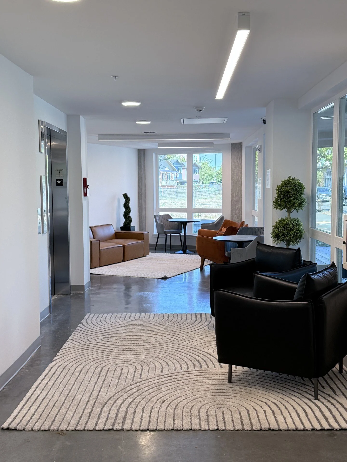 Shared community sitting and lounge area available to all residents, designed for relaxation, connection, and everyday comfort.