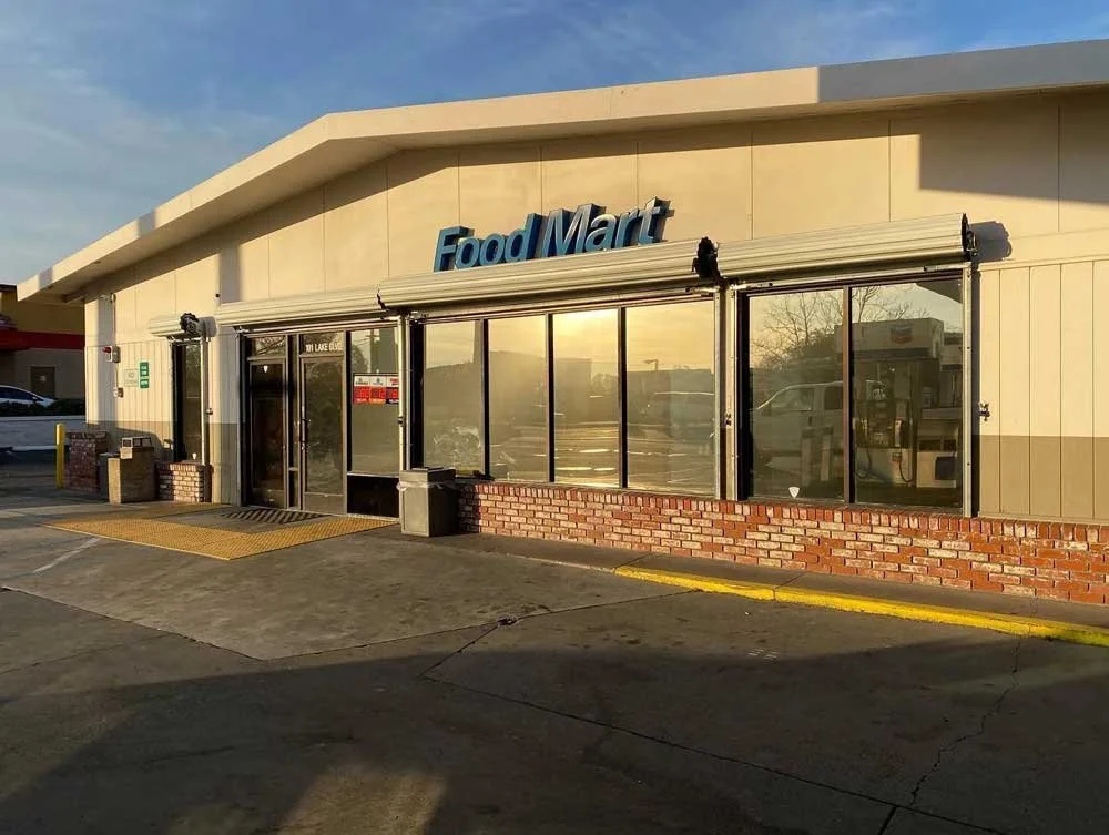 Exterior of a Food Mart grocery store with glass window tinting, commercial window tints near me