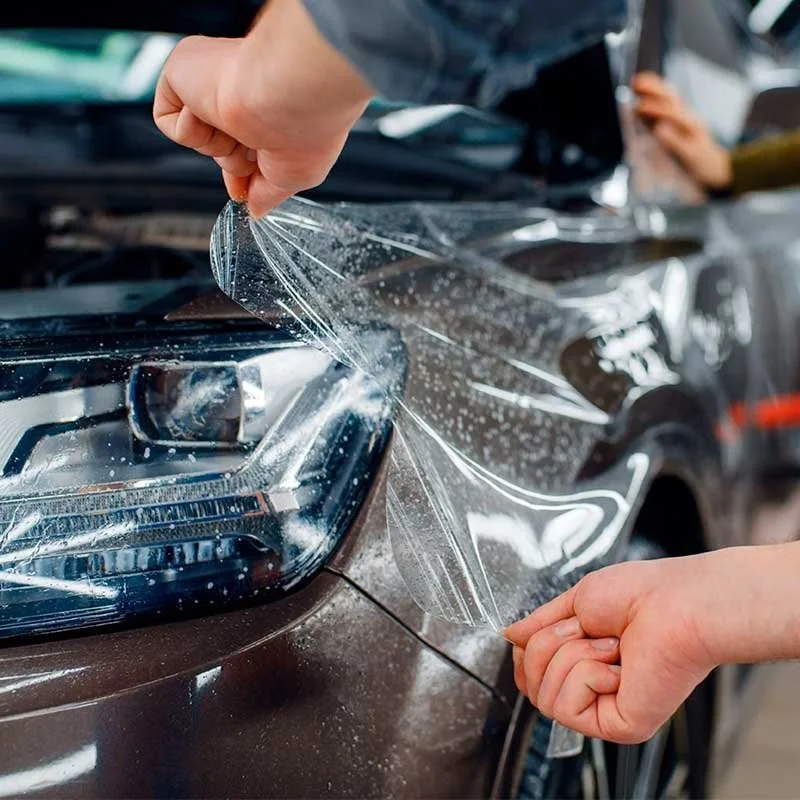 Person applying automotive protective film on vehicle in Redding need PPF near me from Reeves Window Tinting