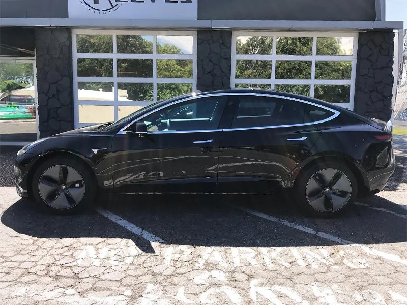 A black Tesla Model 3 with window tinting and PPF by Reeves Window Tinting in Redding, CA