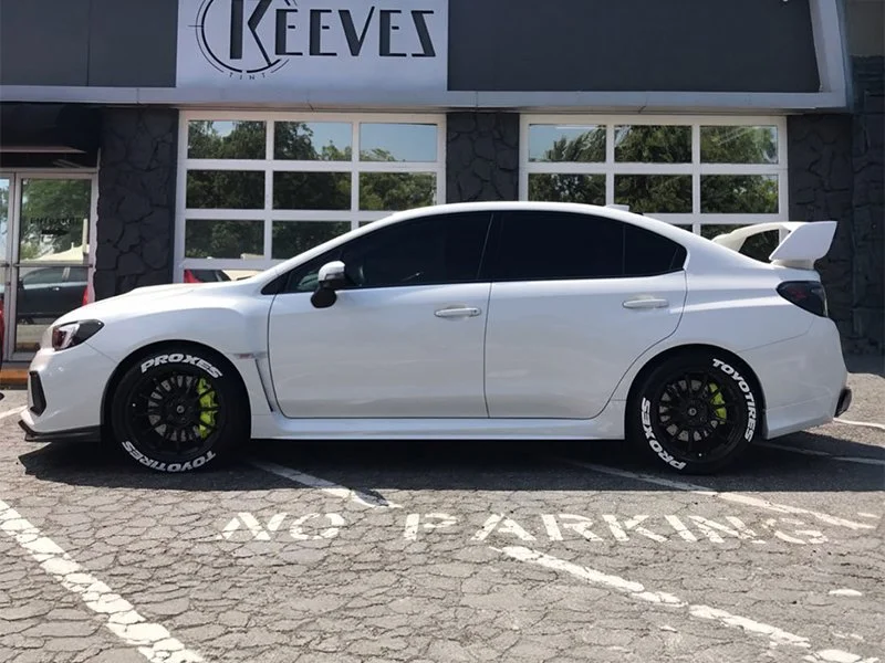 White sedan with black tinted windows and auto paint protection film for cars in Redding, CA by Reeves Window Tinting