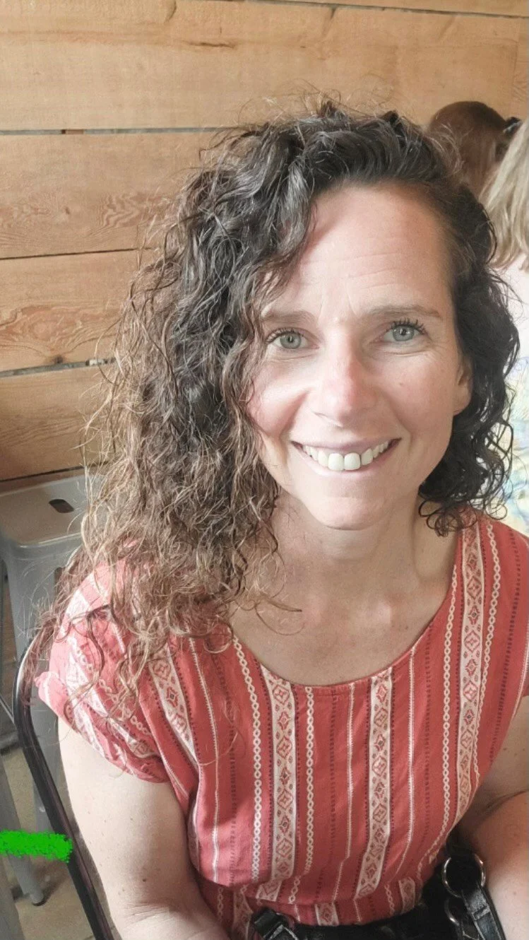 Postpartum Doula with The Devoted Village Lydia Sullivan smiling for photo in Long Island, NY.