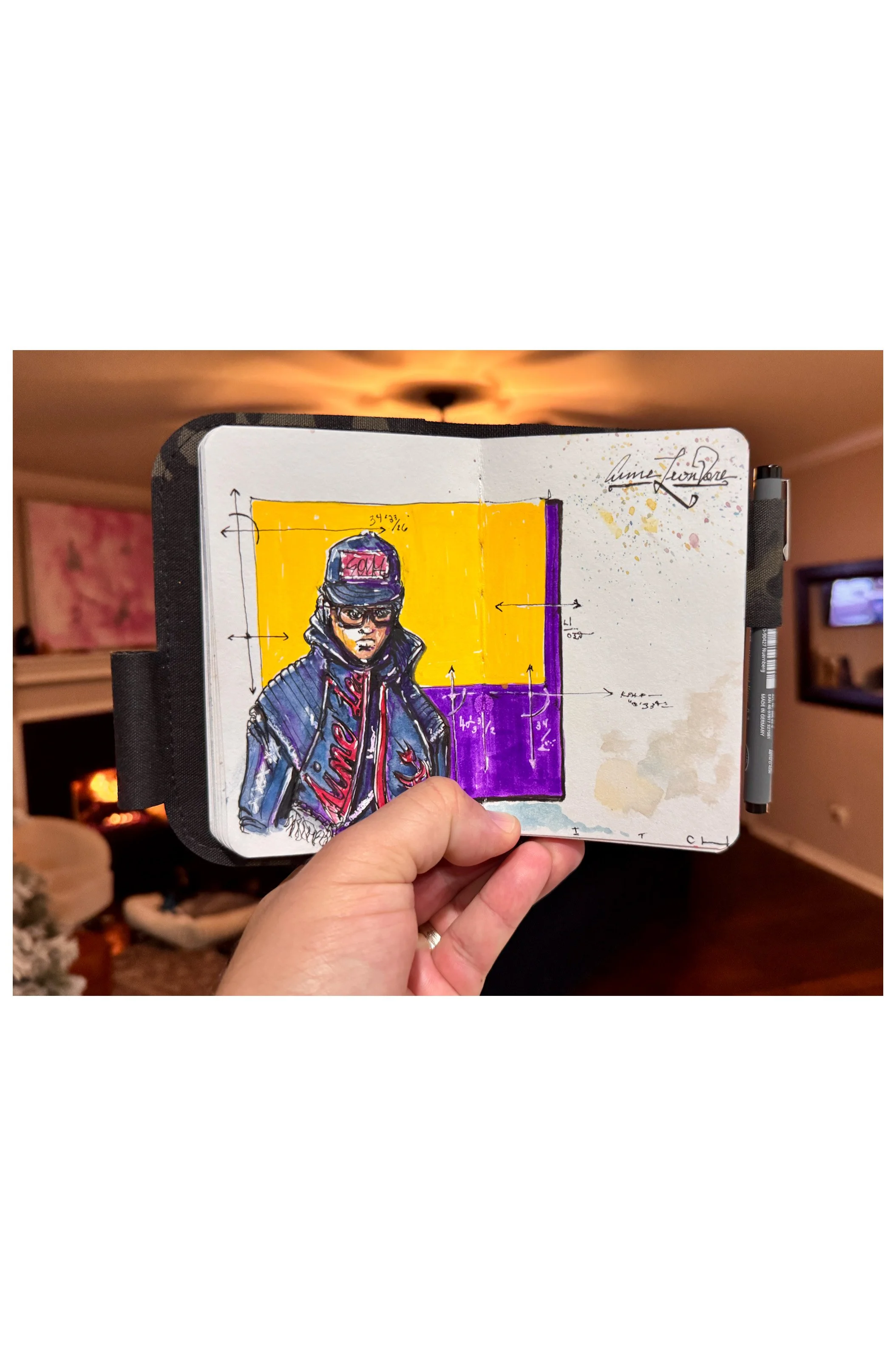 Sketch of a person wearing a baseball cap, glasses, and a jacket, with a background divided into yellow and purple sections with measurements and annotations, in a small sketchbook.