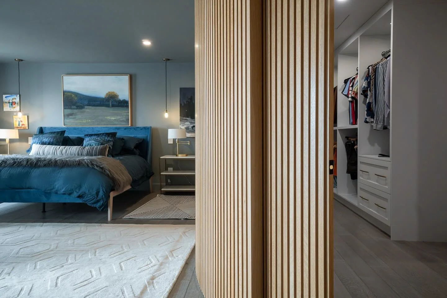 Yes this is a curved pocket door.
 One of the trickier items on this project to build and execute, but we had to have the curved slat wall into the master bedroom, and the pocket door took up the least amount of space getting into the master closet. 