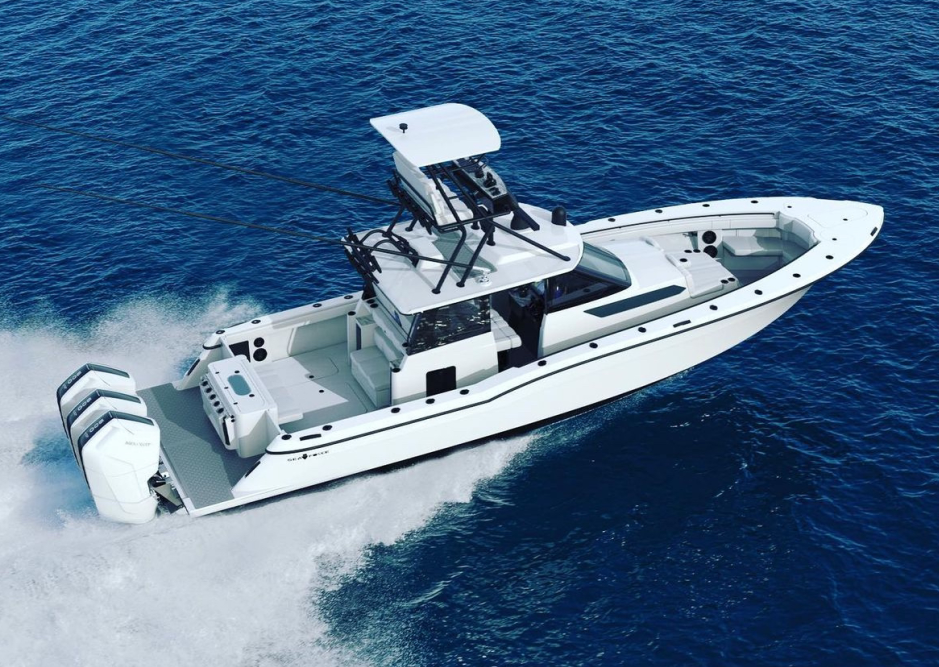 A white luxury motorboat with twin engines speeding through the ocean