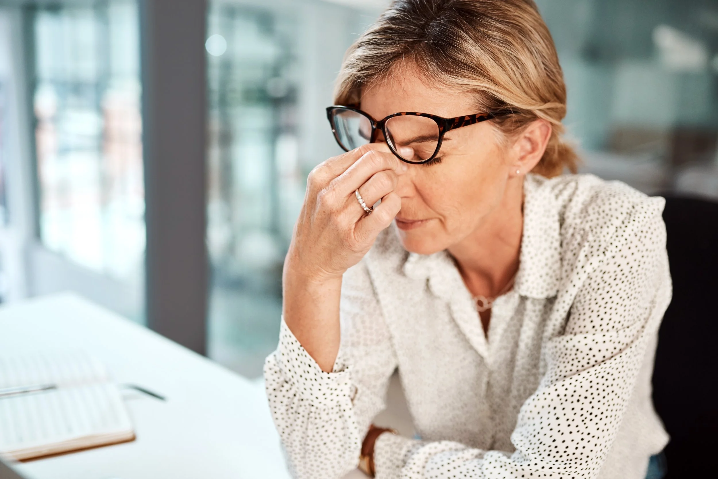 Woman rubbing dry eyes.