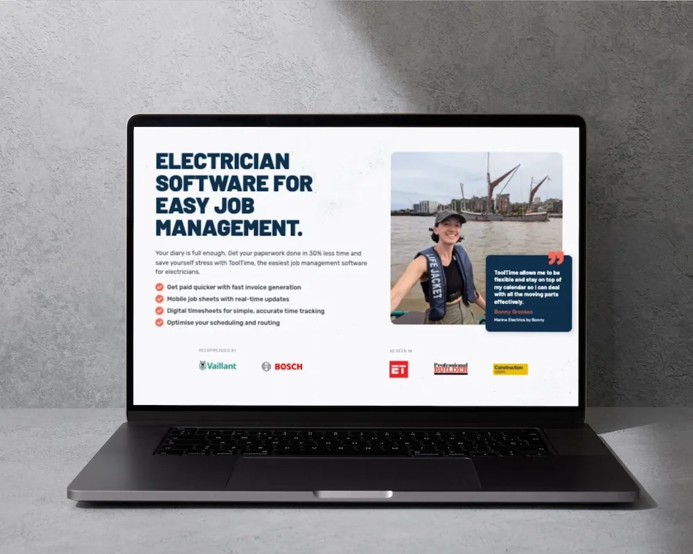 Laptop screen displaying an advertisement for electrician software with a woman smiling on a boat and various logos.