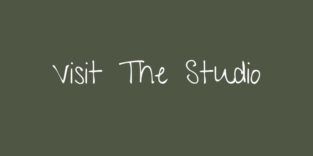 Green background with white handwritten text that reads 'Visit The Studio'.