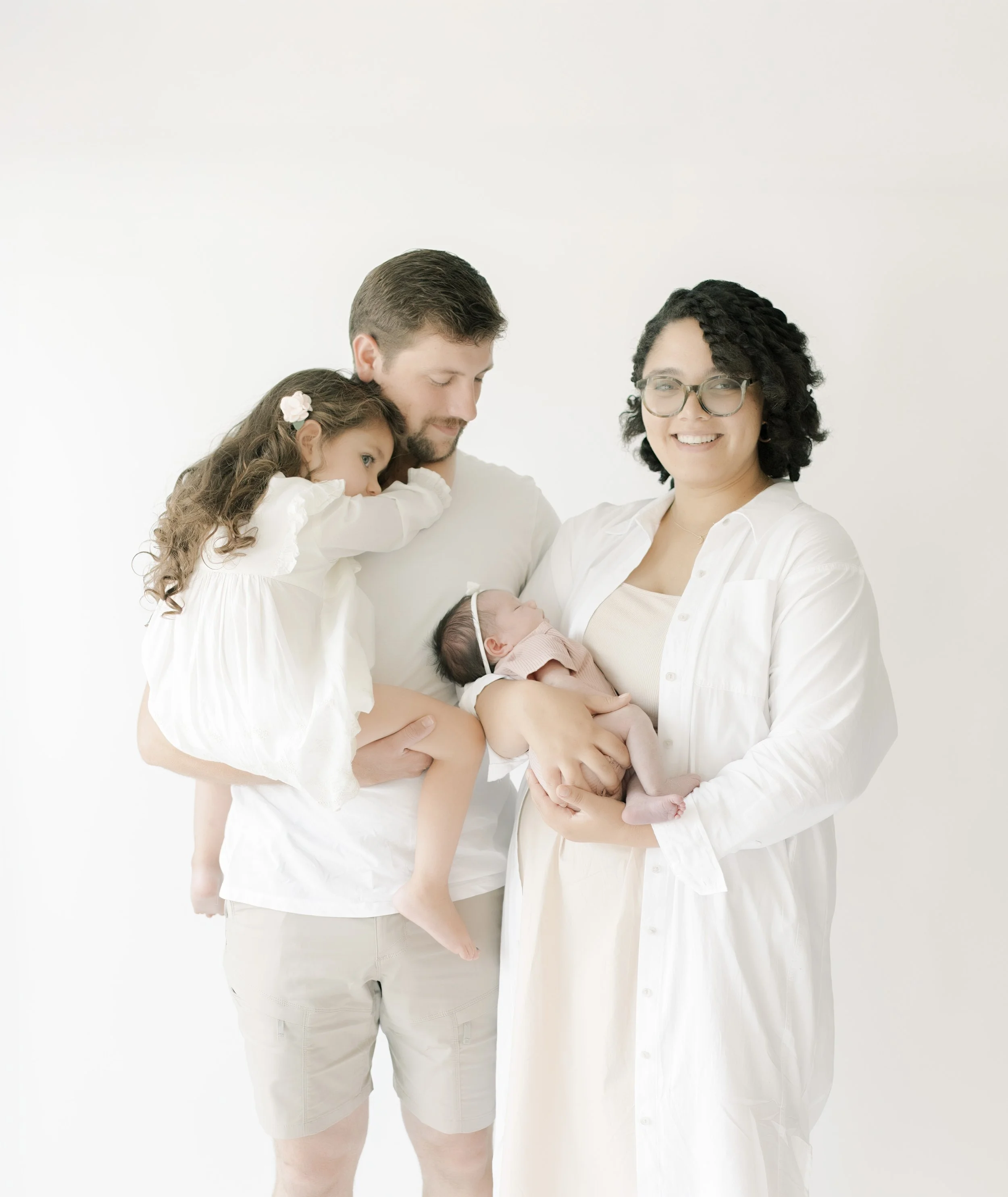 Family of four in light neutral tones during in-home newborn session – Virginia Beach family photographer
