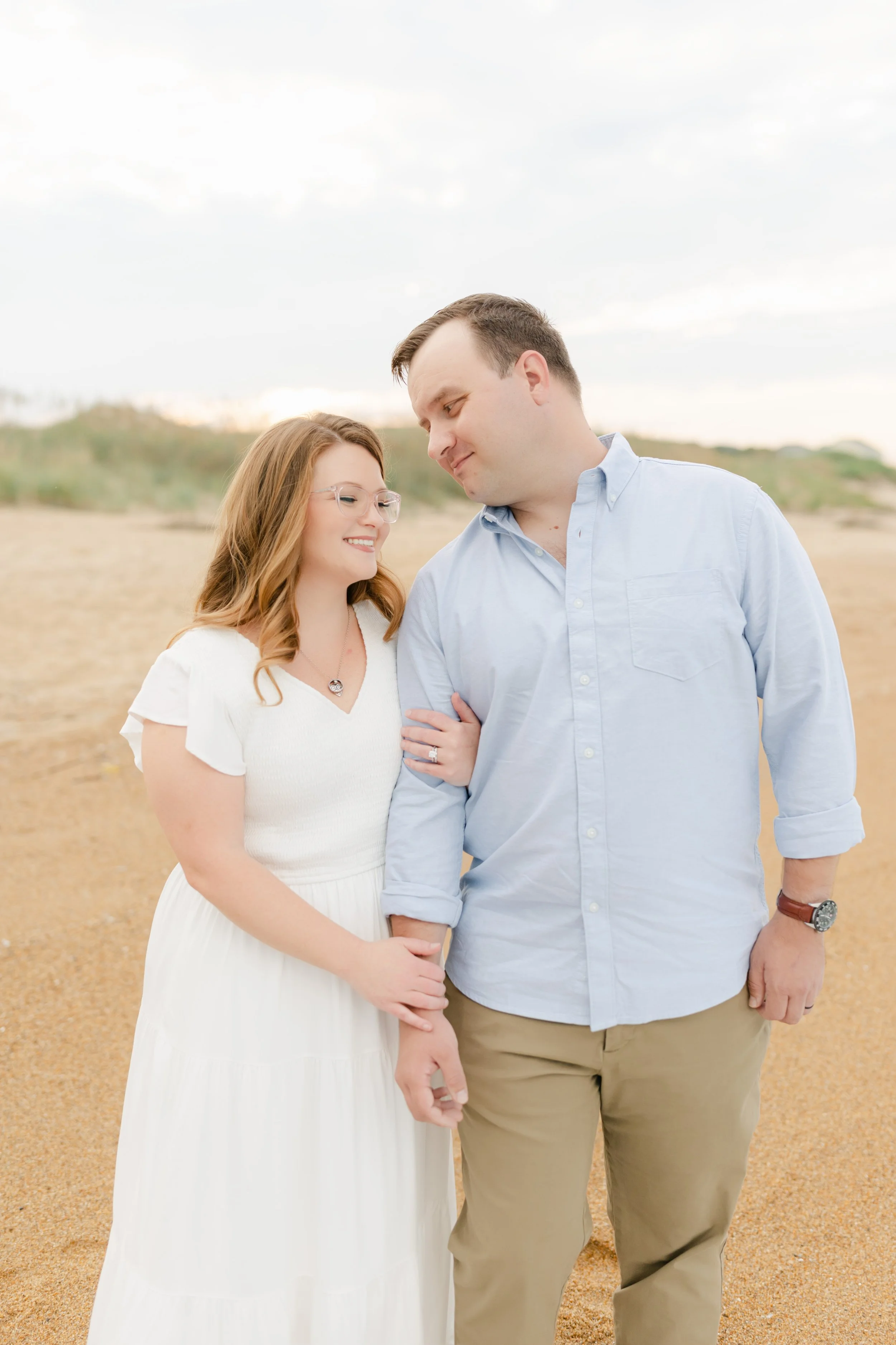 omantic couples session on the beach in Virginia Beach, featuring soft, natural light photography.