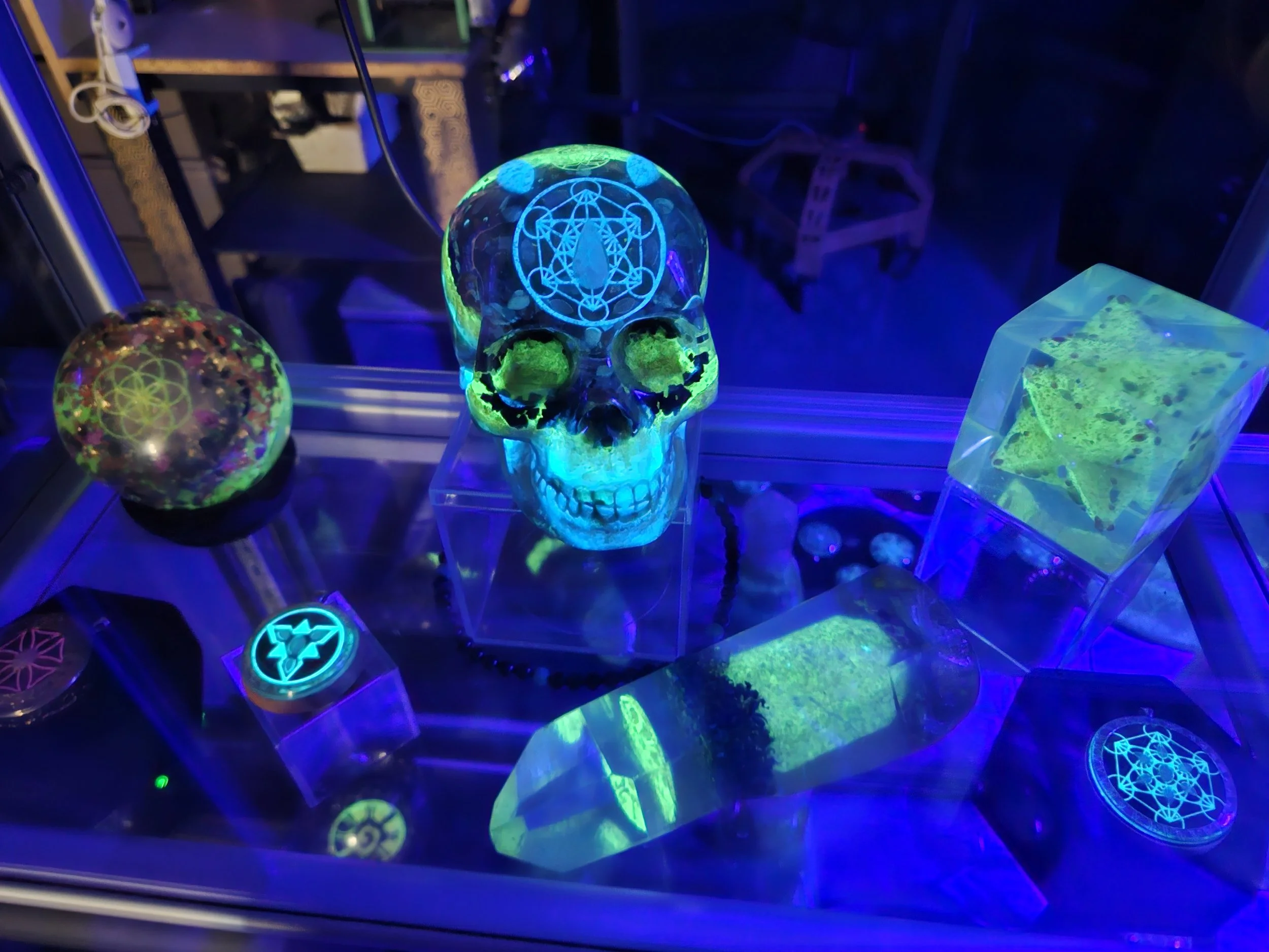 Crystal skull with cube and sphere orgonite pieces in studio display