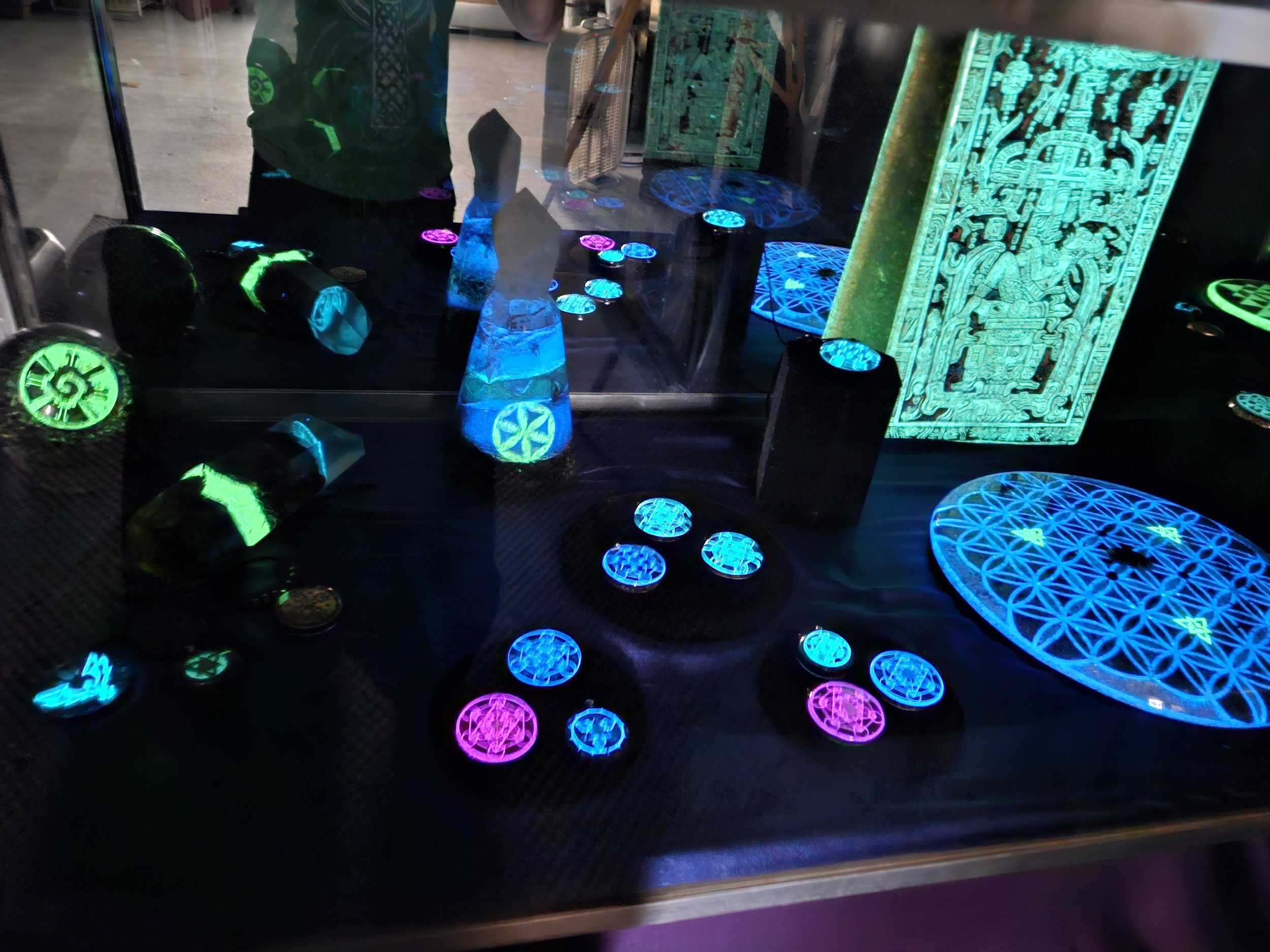 Wide view of Orgonix UV cabinet with glowing orgonite collection