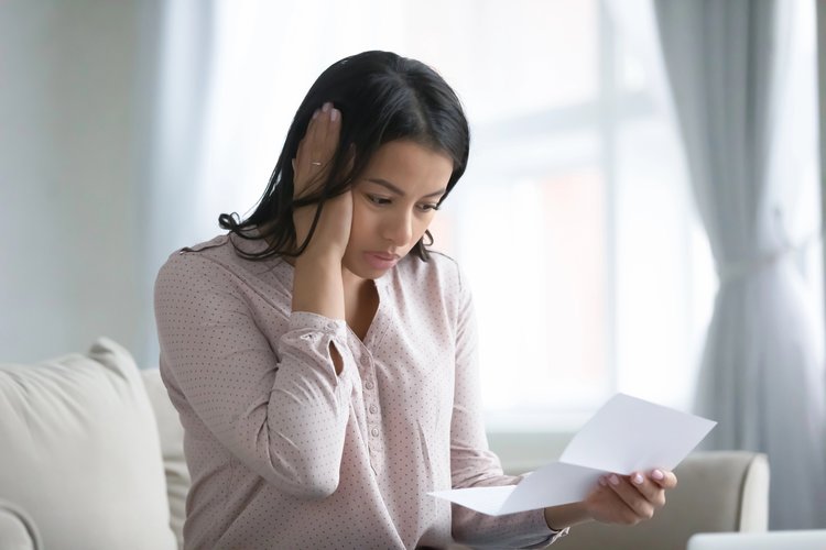 Patient looking at medical bill with surprise expression