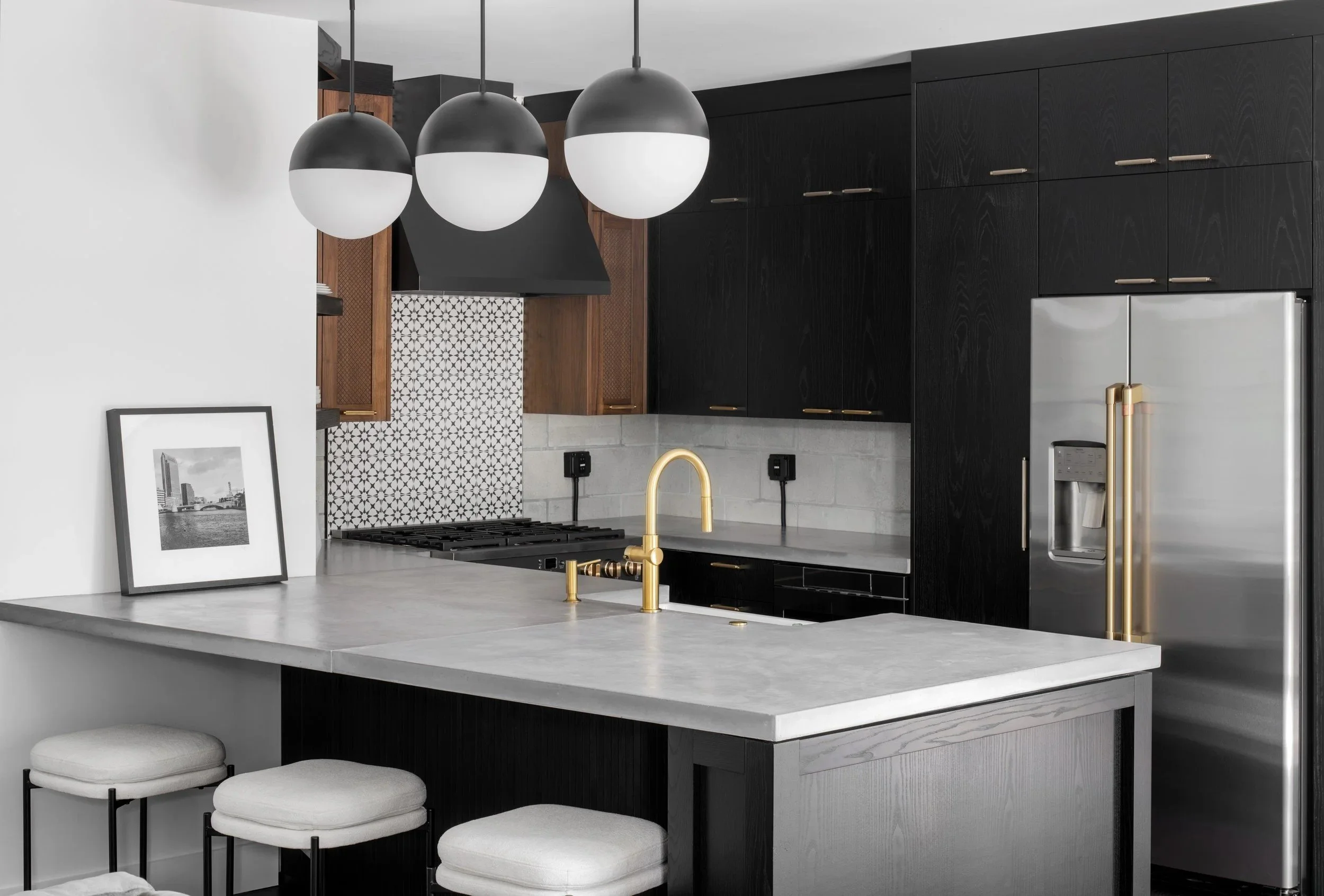 Black custom kitchen cabinetry with brass details by BUILT, Tampa