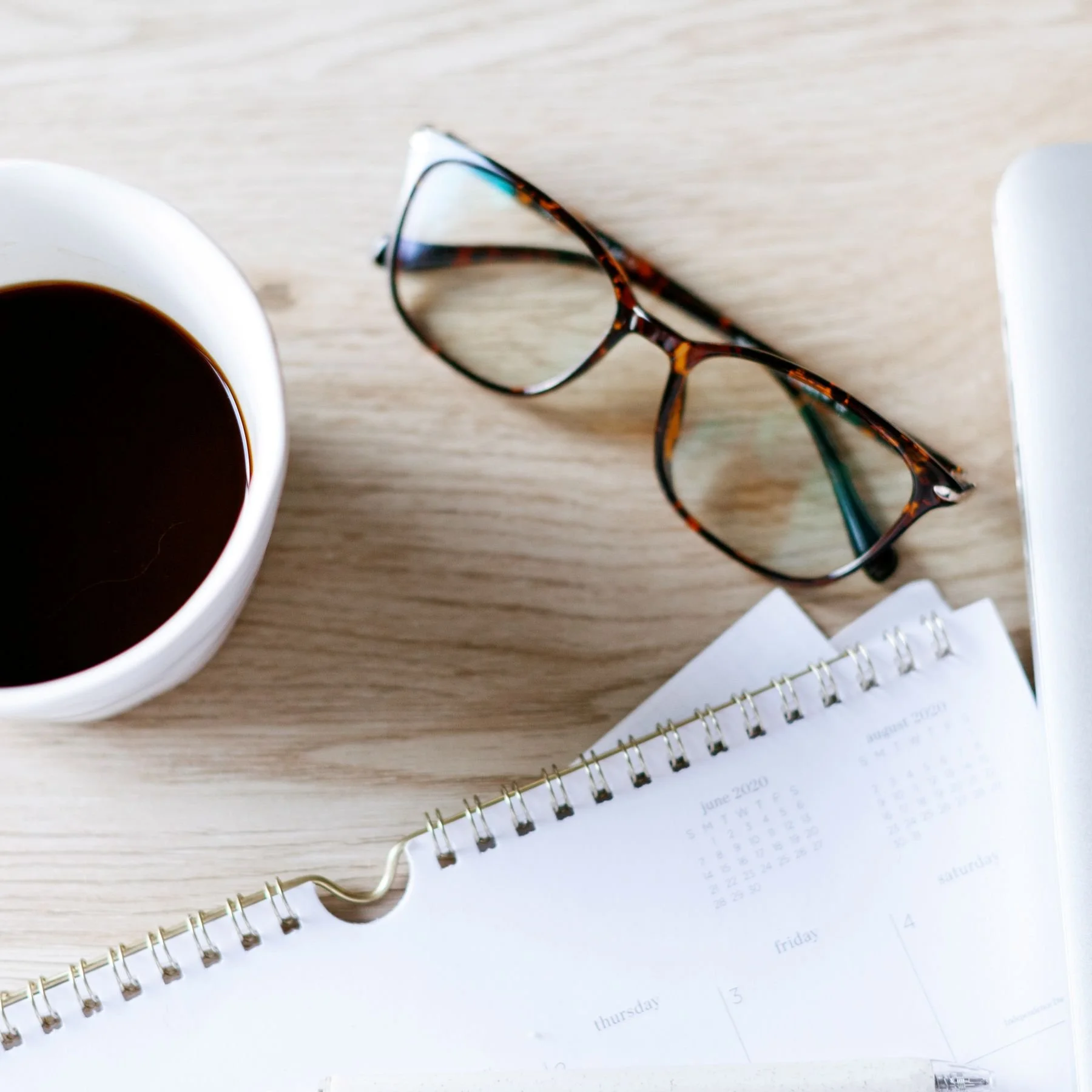 notebook-black-coffee-folded-glasses