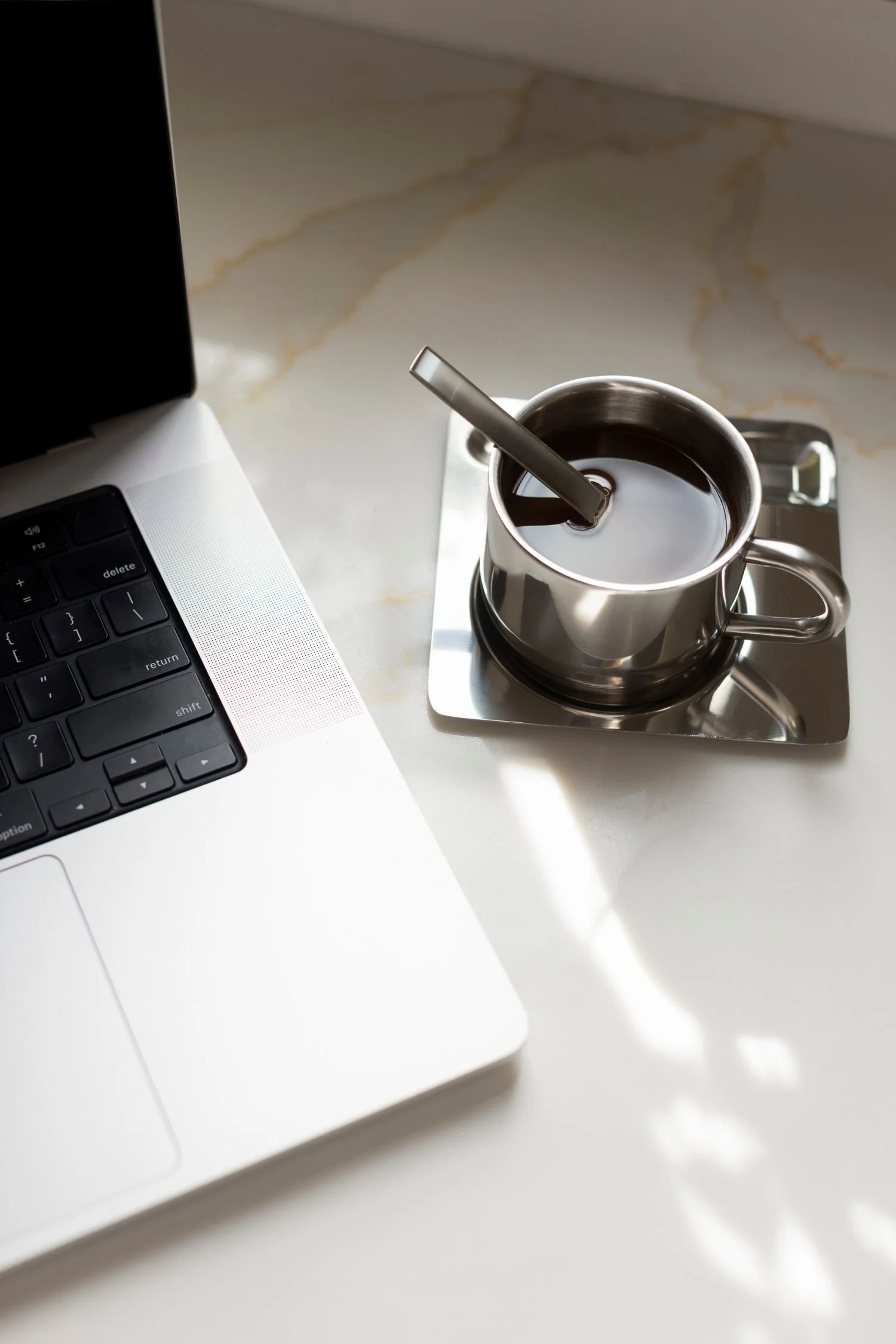 laptiop on desk with coffee cup