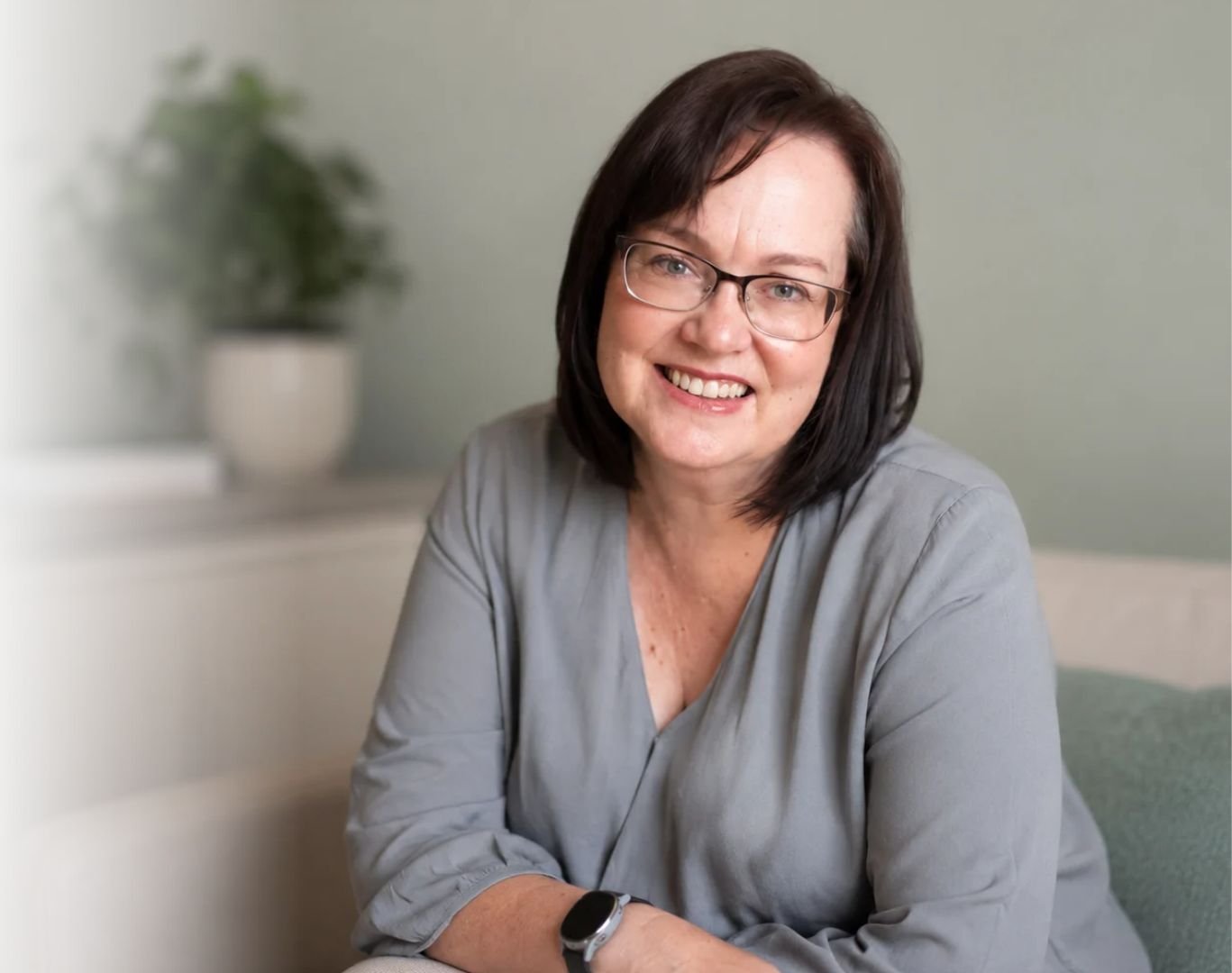 friendly woman with shoulder length dark hair and glasses