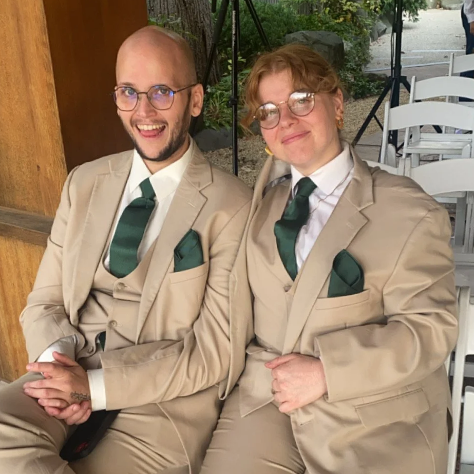 Kara and Joseph in fancy matching suits look playful