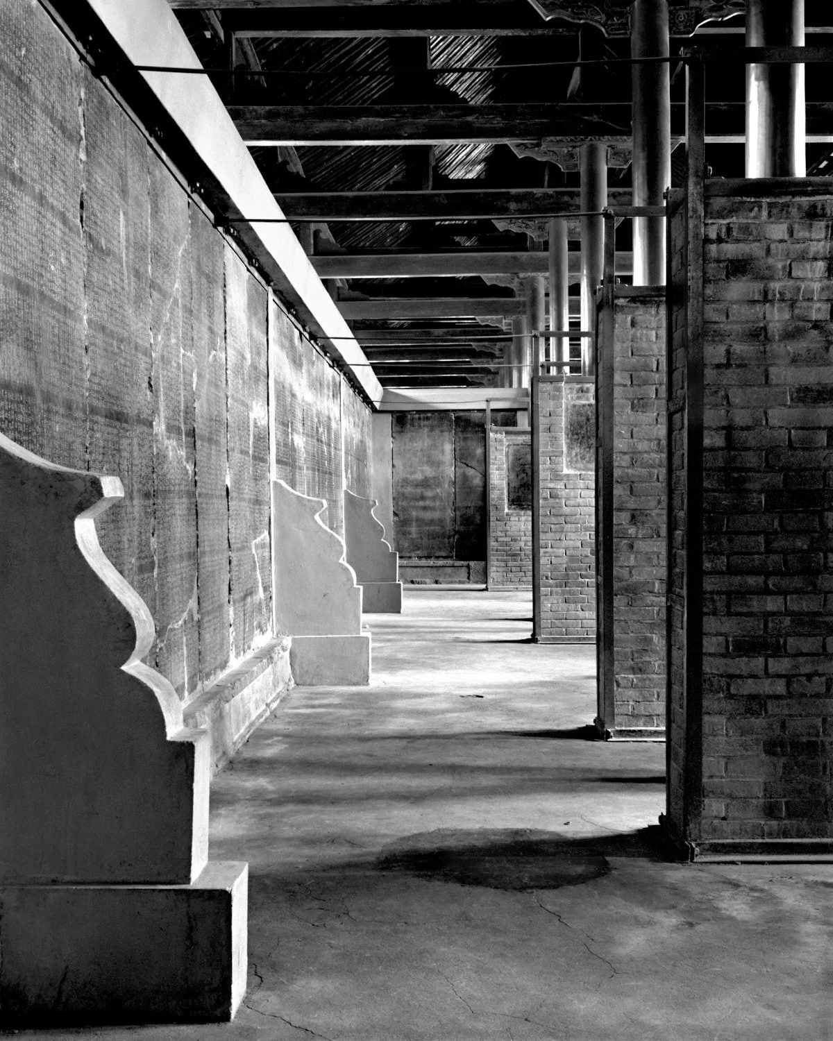 Interior corridor of the Bei Lin Stone Steles Museum in Xi’an, 1988, with stone tablets mounted along brick walls.