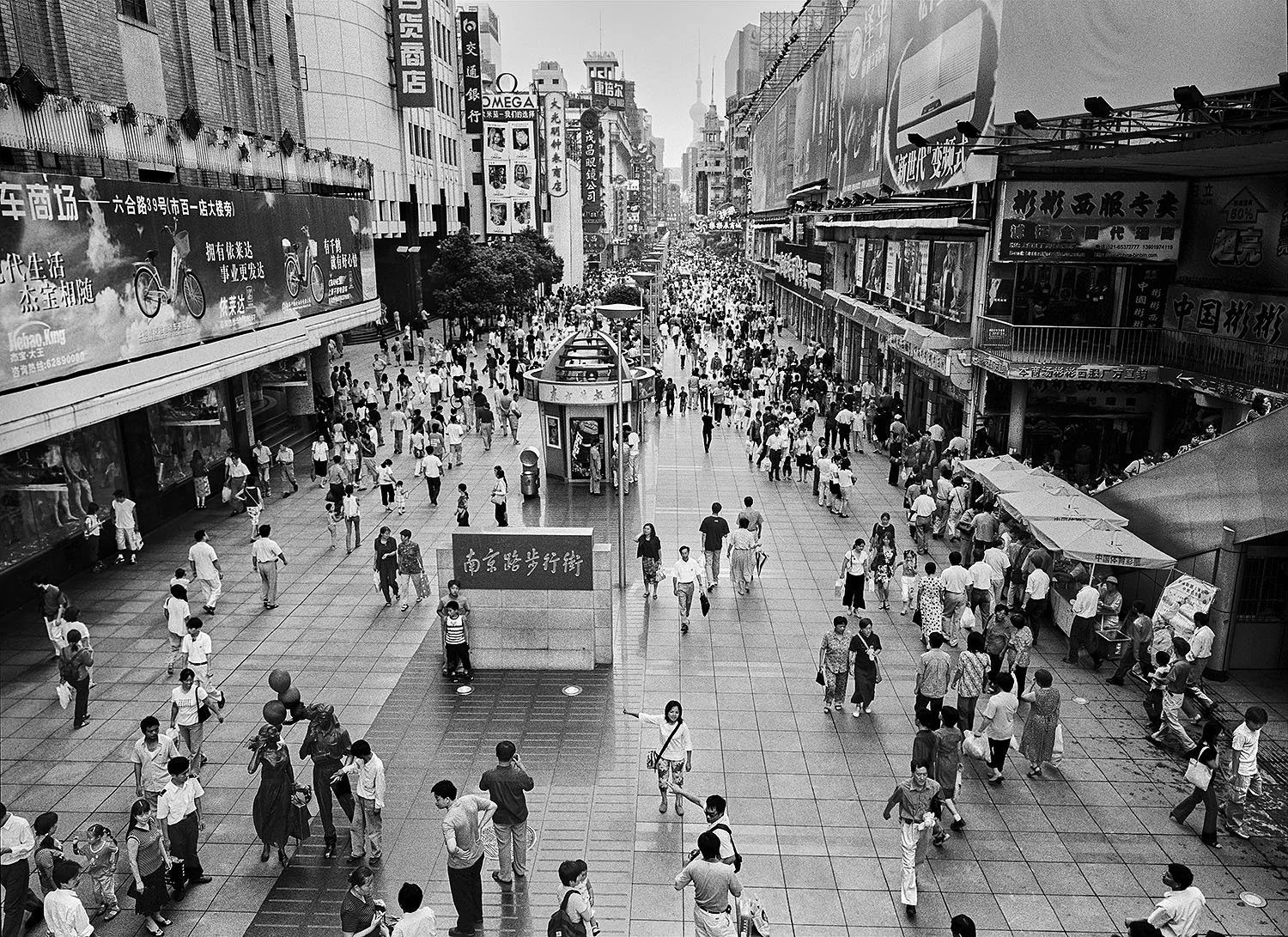 Crowds of pedestrians walking along Nanjing Road in Shanghai, 2001, viewed from an elevated vantage point.
