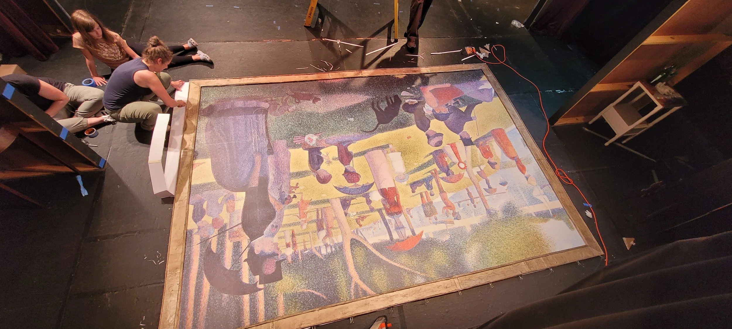 Sunday la Grande Jatte Install progress. Maria attaching frame to outer edges of painting.