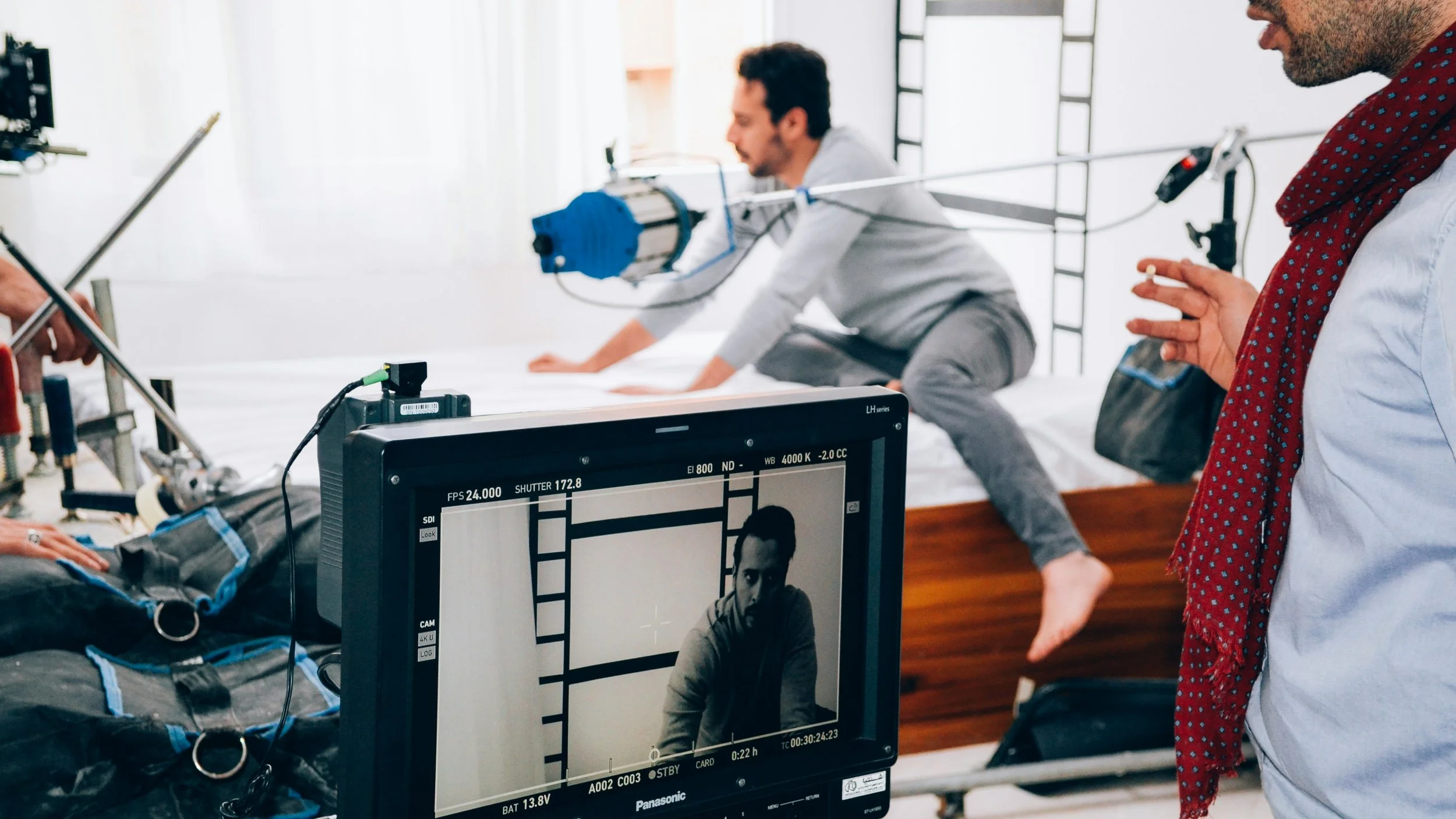 Sam sitting on a table to plan something. He doesn't wear shoes in the office.