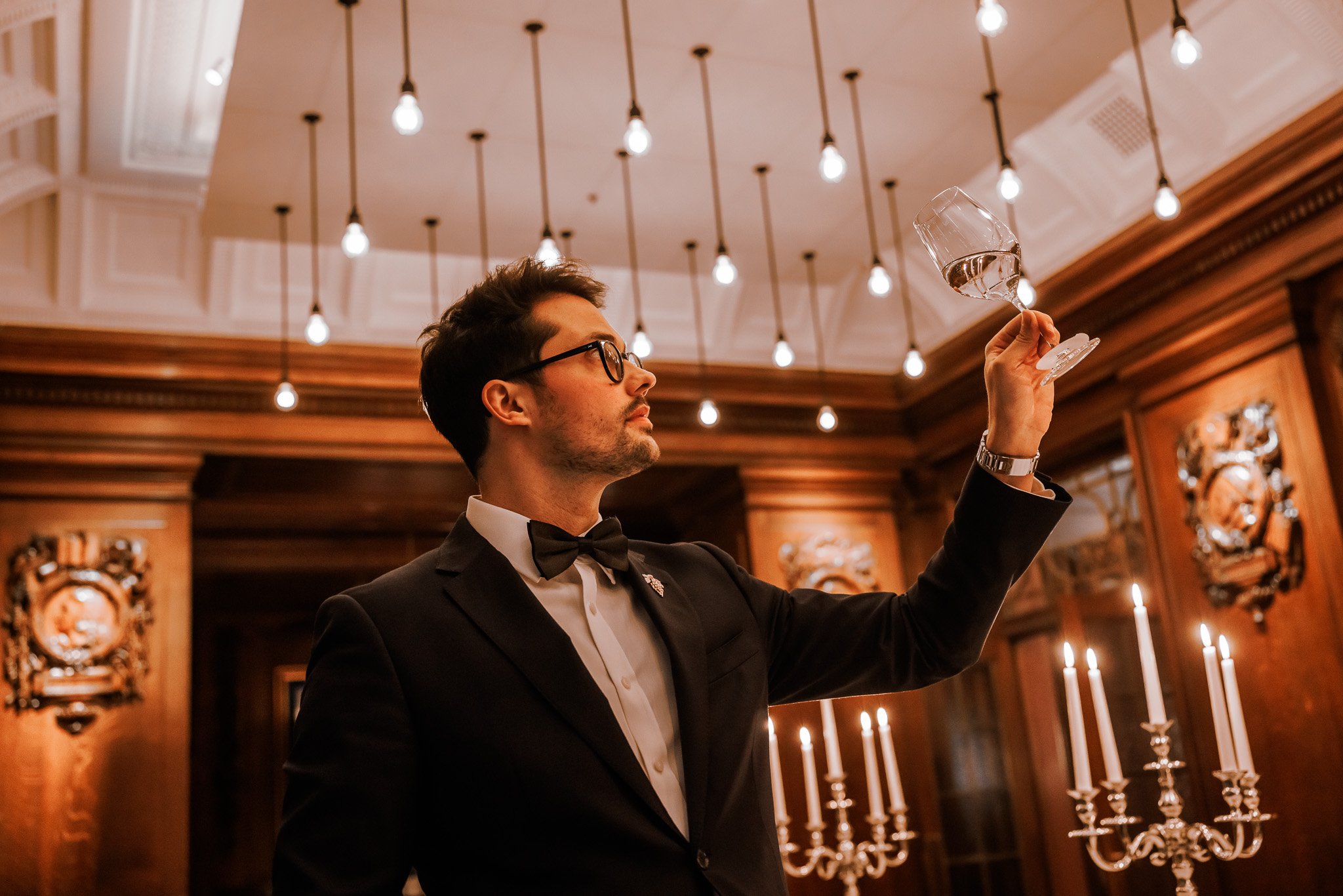 Sommelier presenting wine selection during exclusive company dinner at The Four Seasons Ten Trinity Square