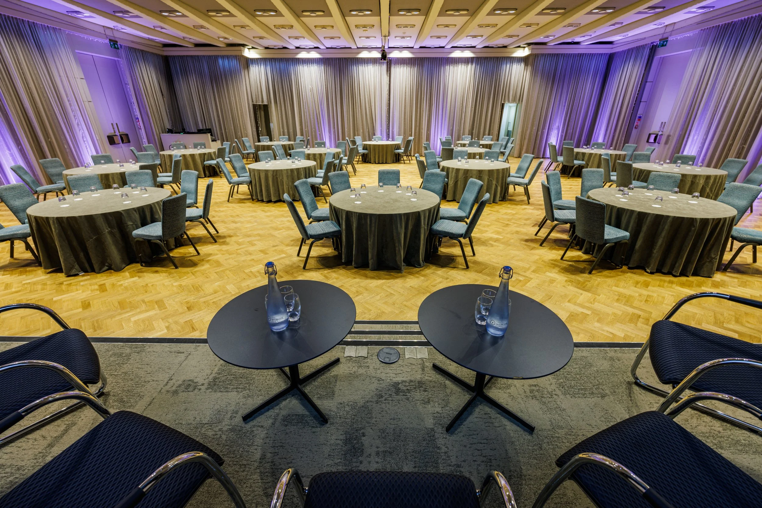 Conference room setup with round tables and chairs