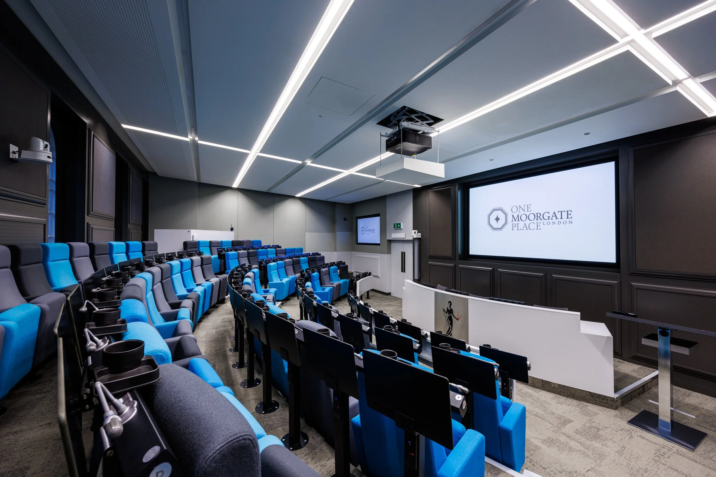 Interior photography of a conference theatre with large projector screen