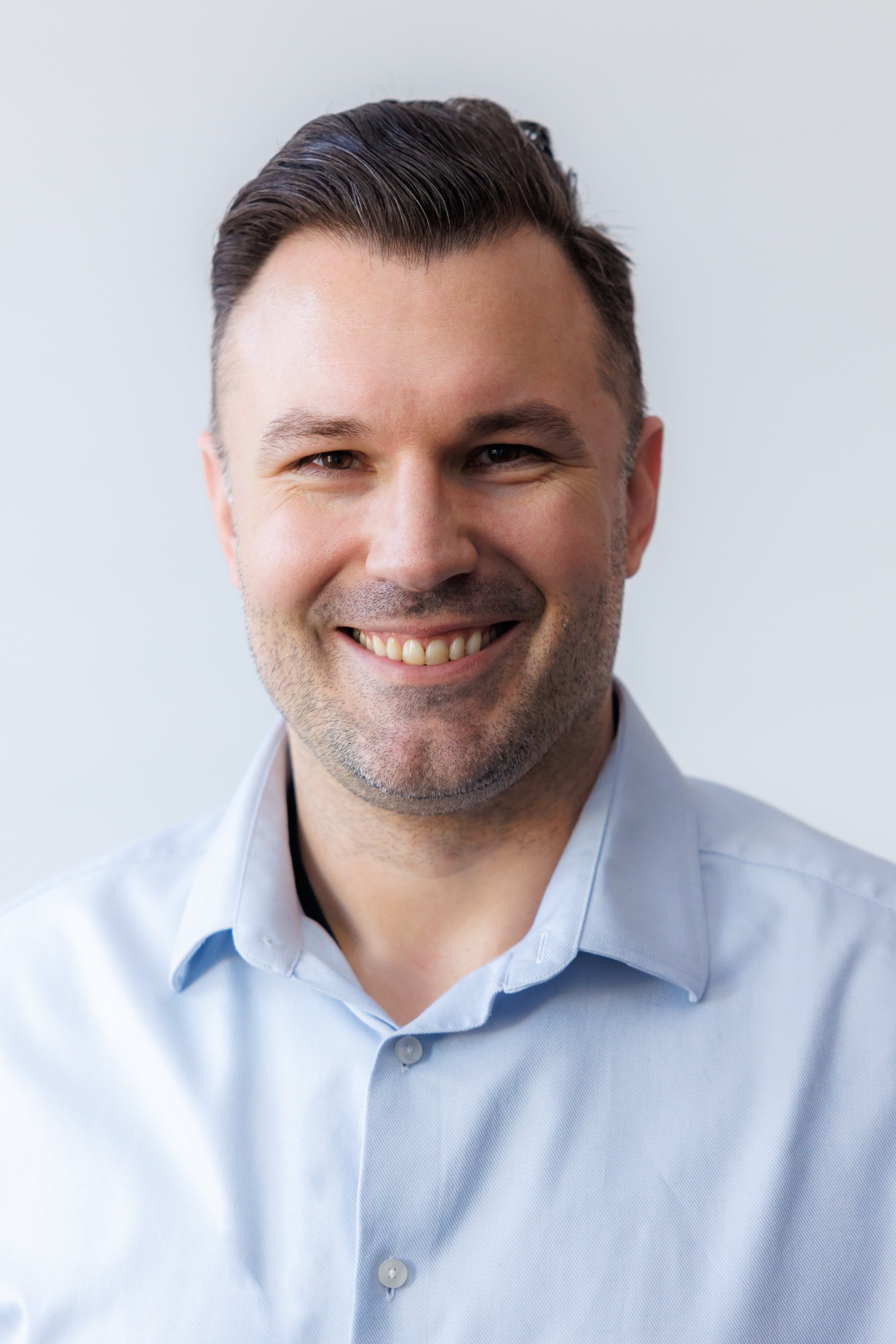 Event organiser corporate headshot with white background and natural light
