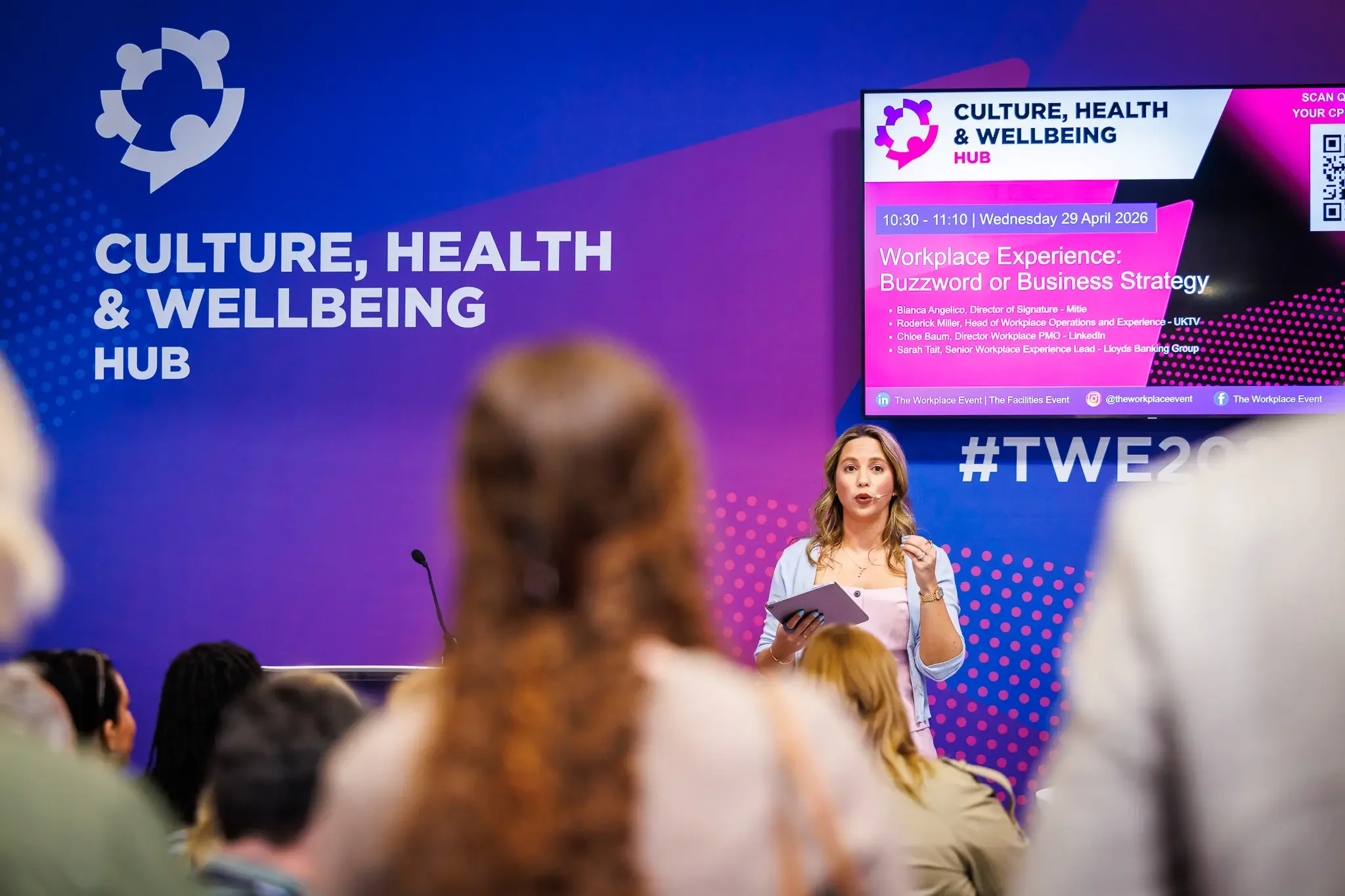Workplace wellbeing speaker addressing business audience at The NEC