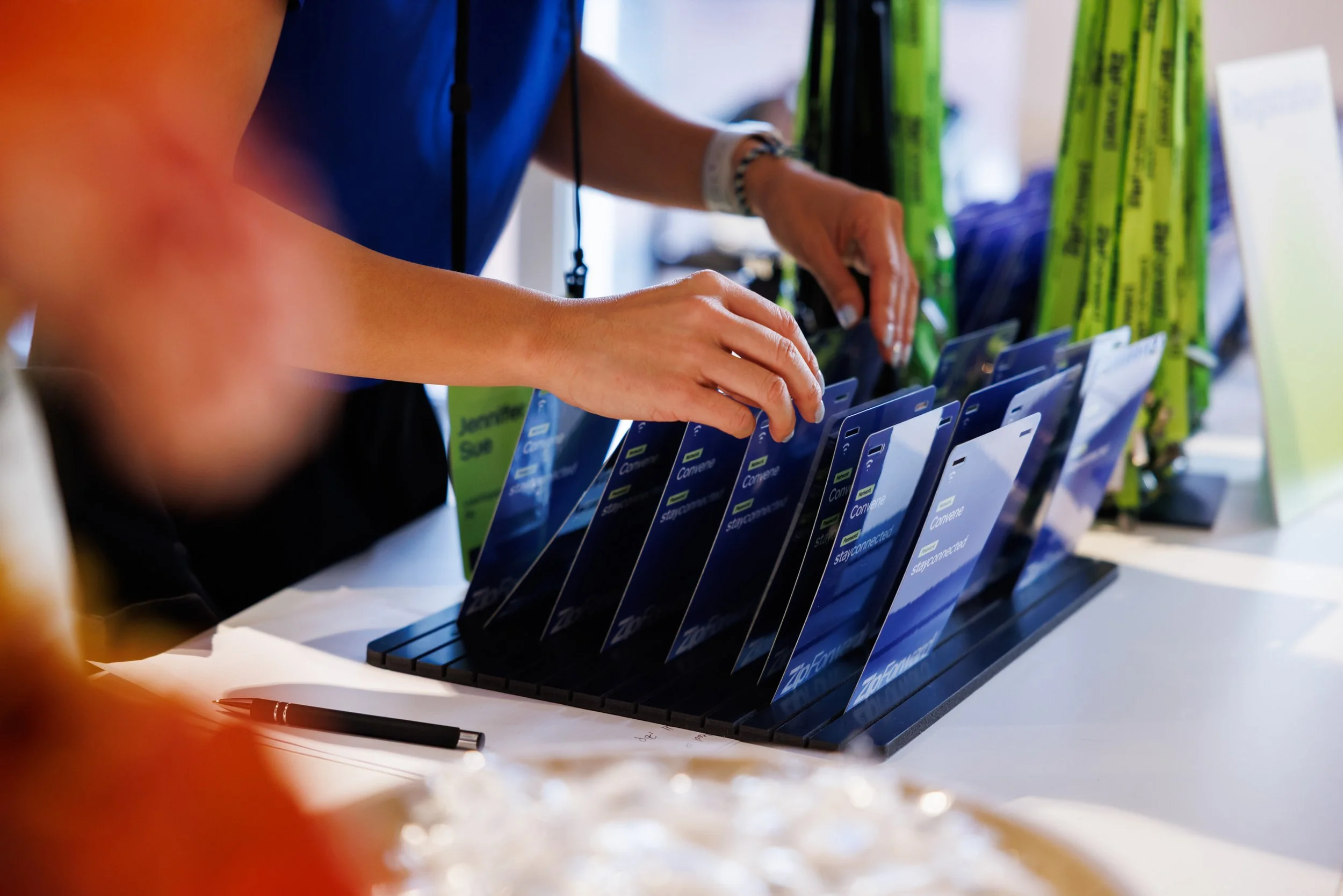 Conference registration desk with branded delegate badges