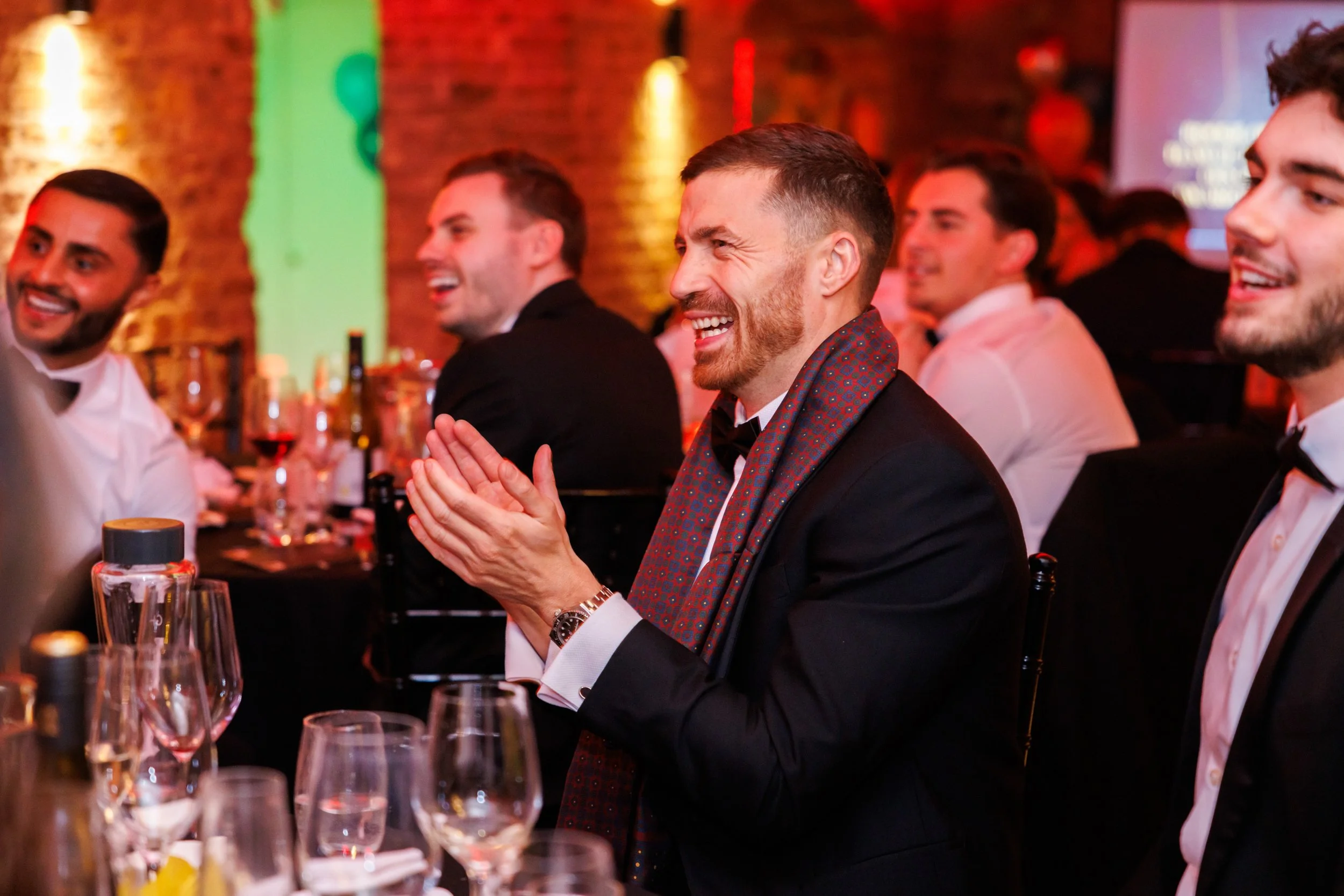 Candid moment of awards audience applauding during gala dinner