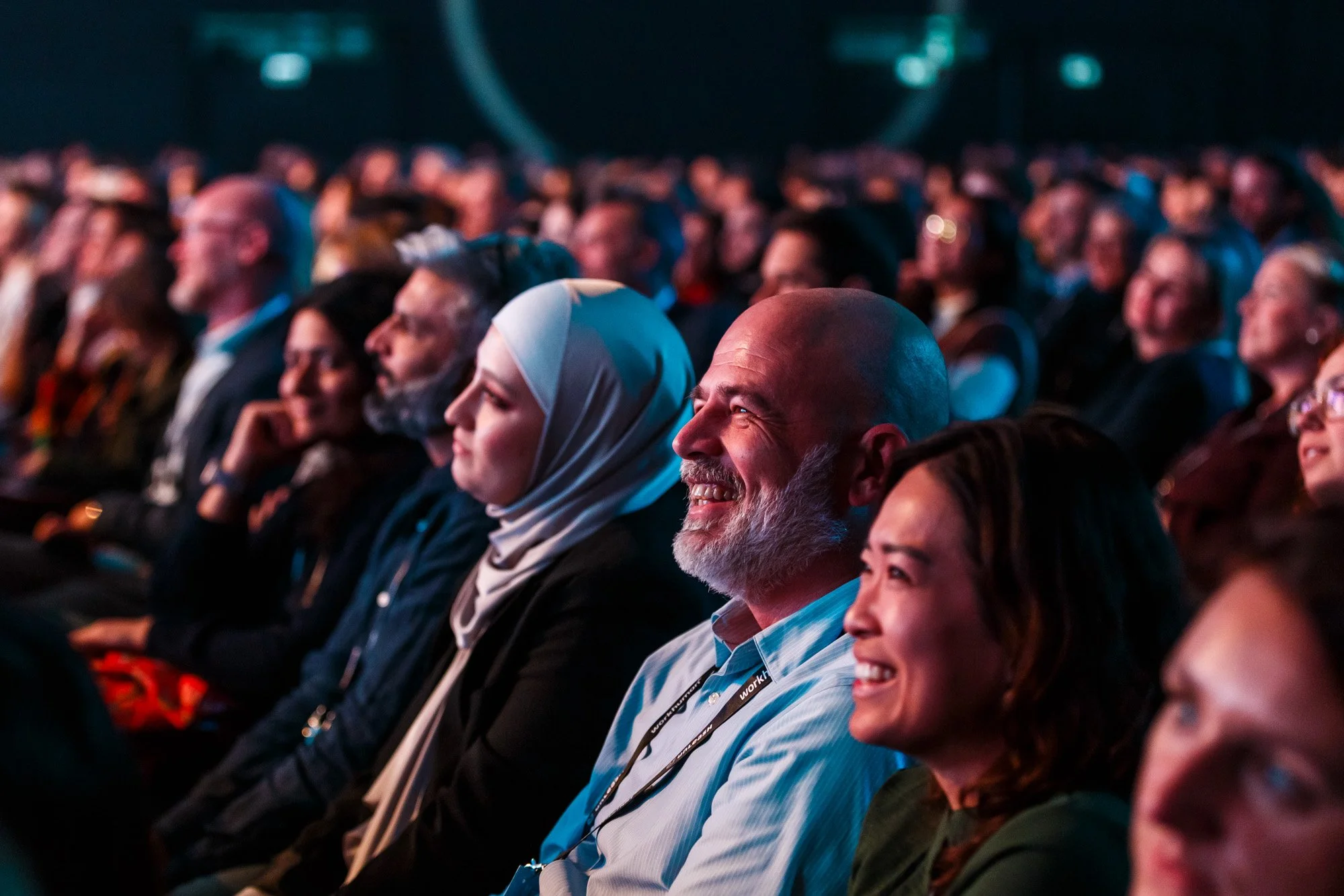 Audience smiling during opening keynote at industry expo