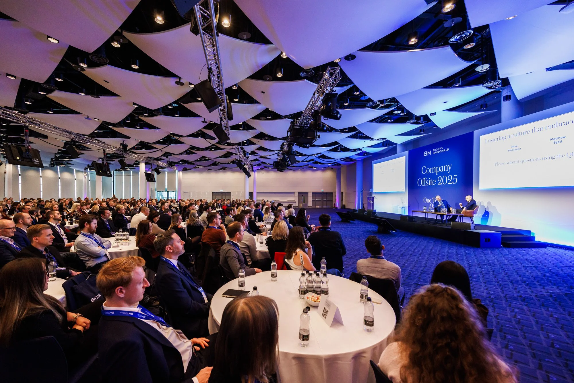 Audience listening to VIP speaker during annual company summit
