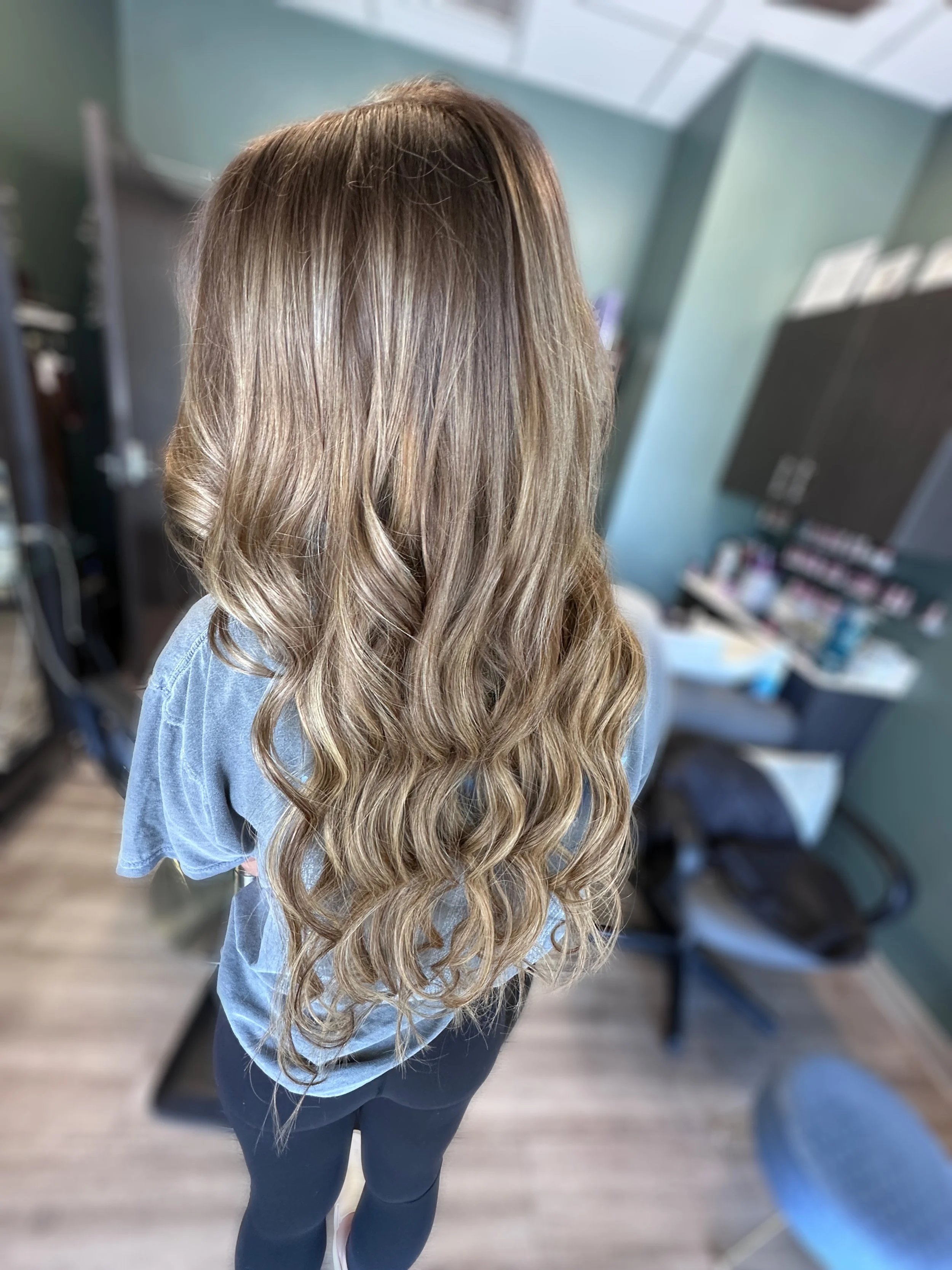 Two rows of hair extensions adding length and volume to fine hair at Mane & Murr Salon in Dallas, TX