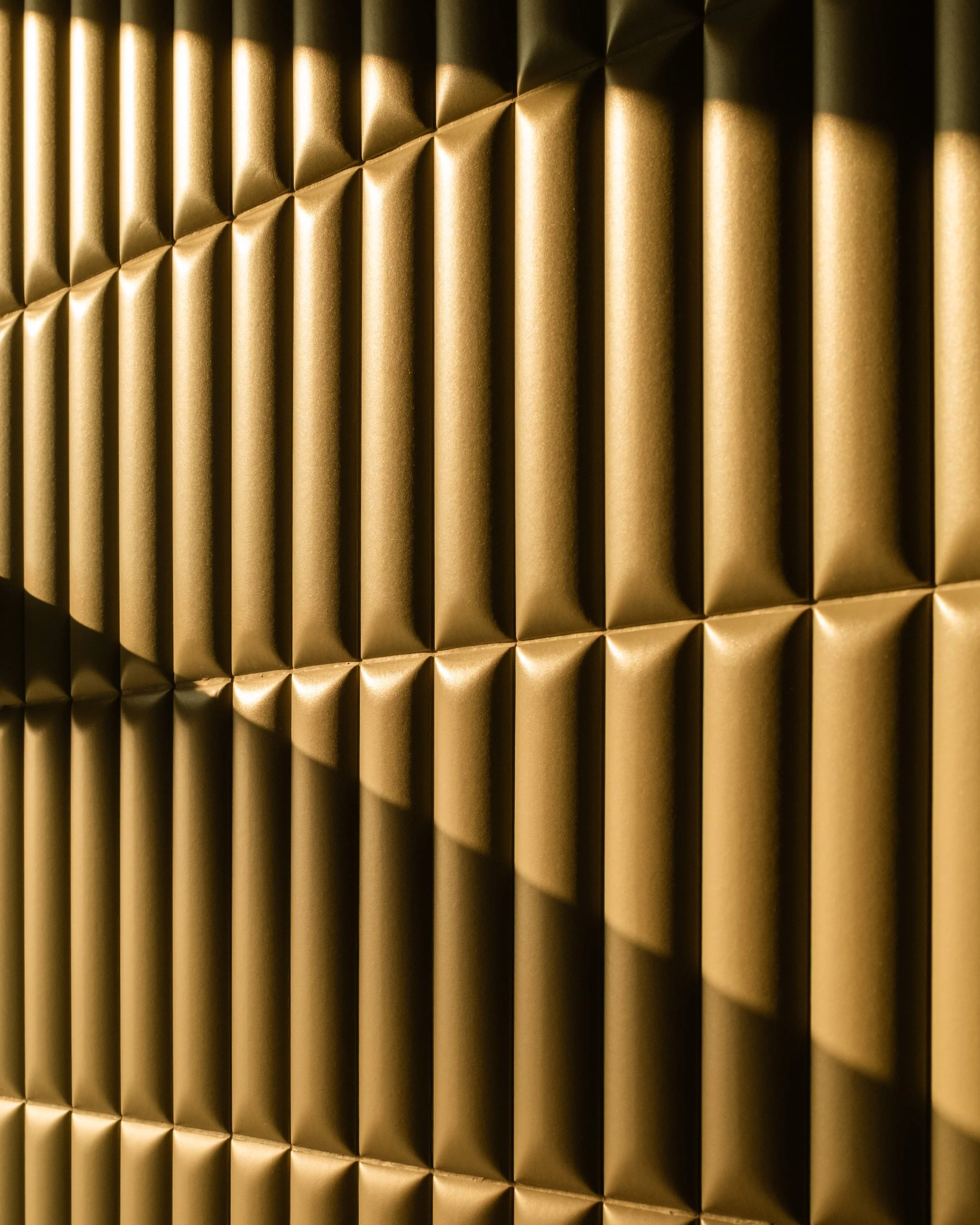 Close-up of wall tiles in a luxury hotel bathroom, illuminated by a ray of bright sunlight. Lionel Chu - Hotel & Travel Photographer