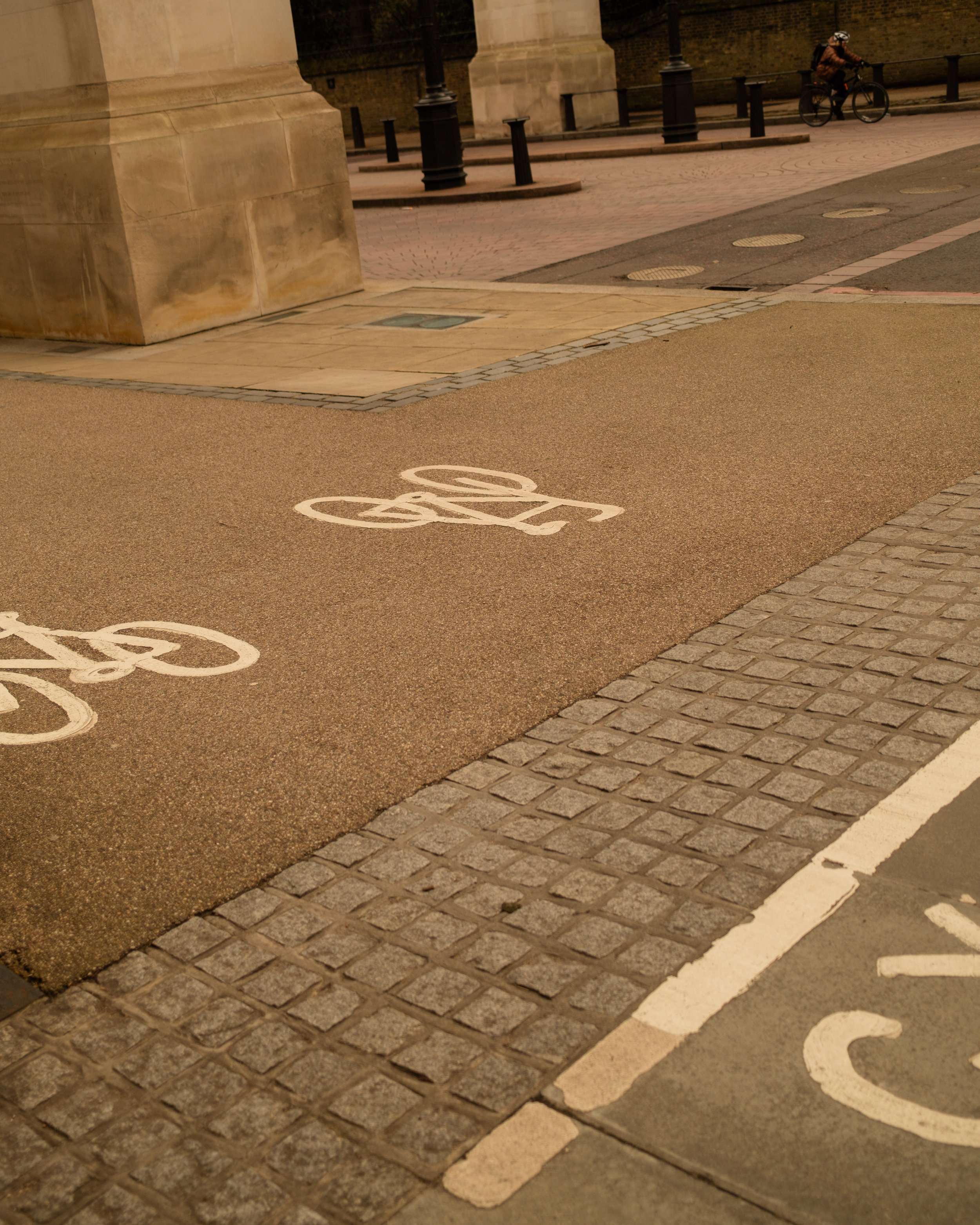 Bicycle lane and bike symbols painted on the street pavement in an urban setting. Lionel Chu - Hotel & Travel Photographer